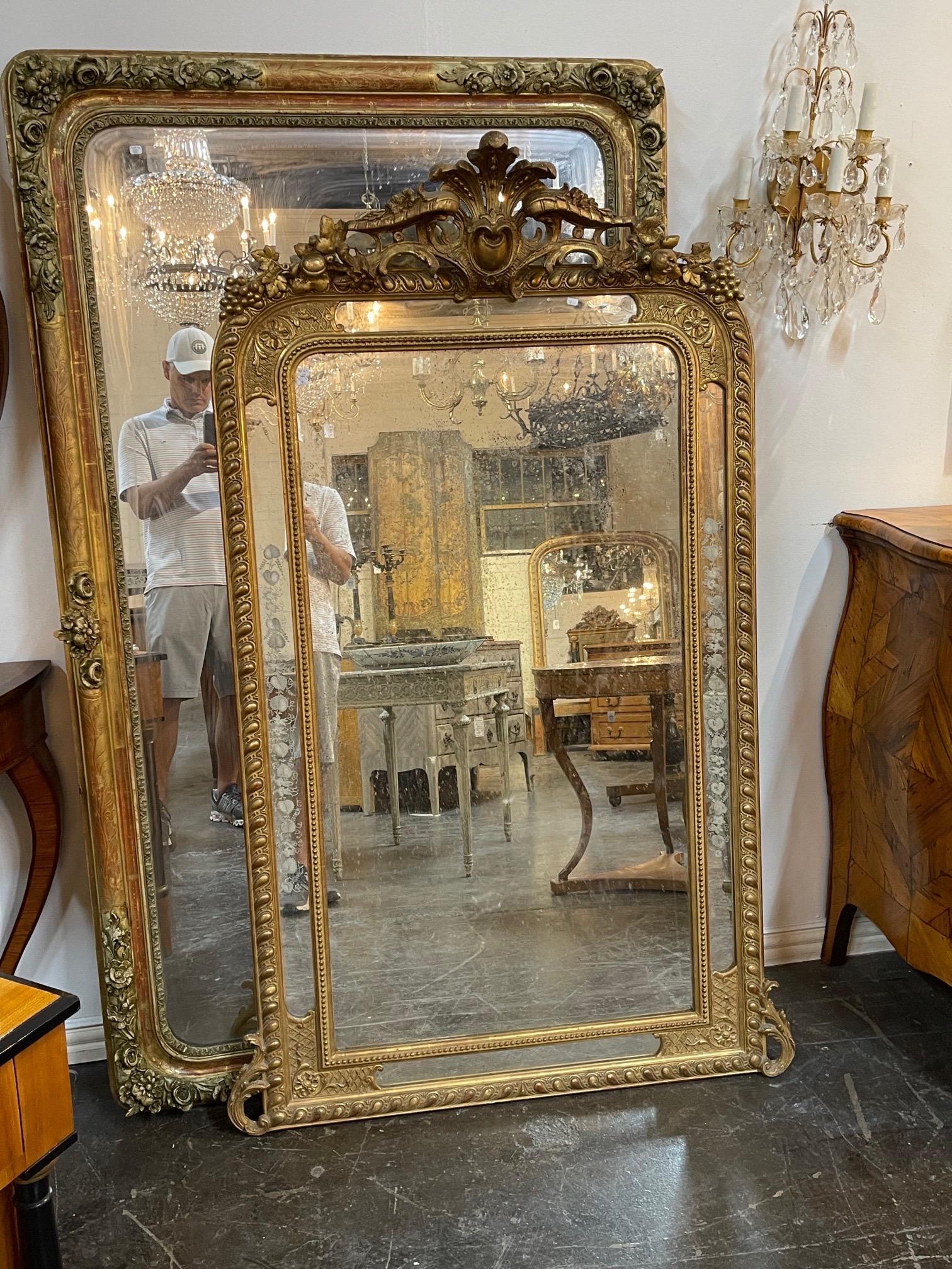 Elegant large 19th century French Louis XVI style giltwood mirror. Beautiful intricate carvings including an elaborate crest at the top. And pretty etched glass as well. Extra special!!