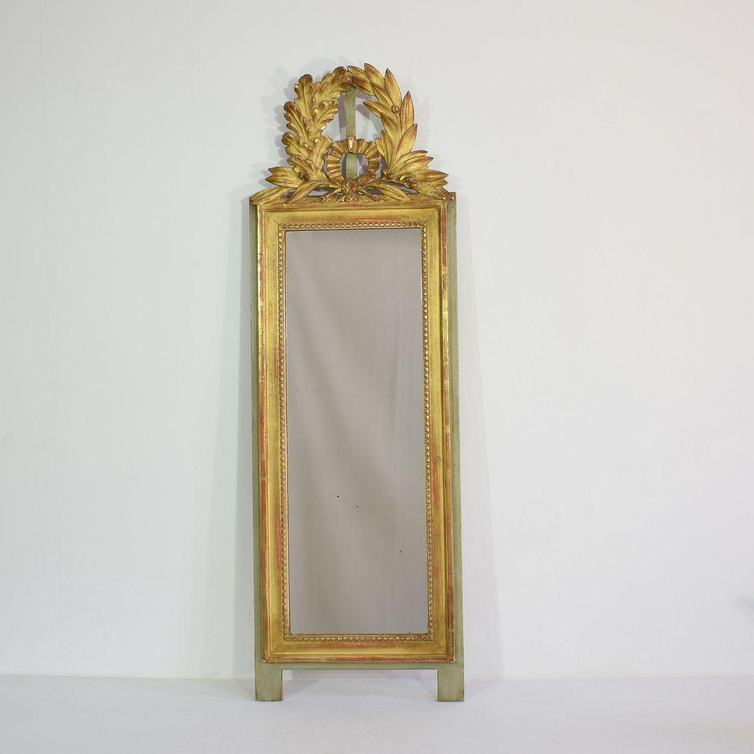 Beautiful and narrow Louis XVI style giltwood mirror, most likely made to hang between two windows.
France circa 1880-1900. Weathered, small losses.
 