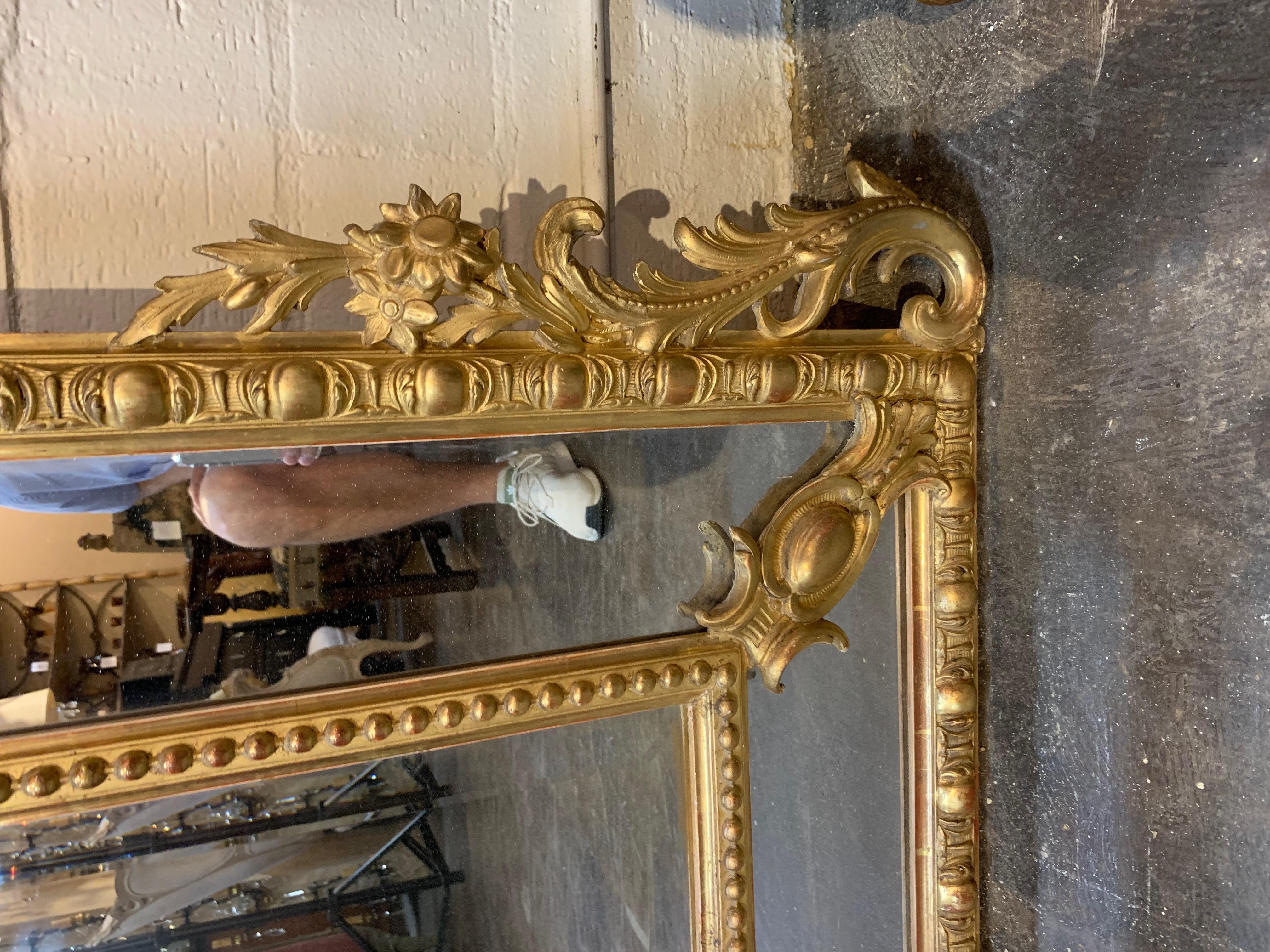 Stunning 19th century French Louis XVI style gold gilded cushion mirror. Lovely gilding with images of flowers, scrolls, leaves and birds. The mirror has original beveled mercury glass.
Makes an impressive statement in a fine home.