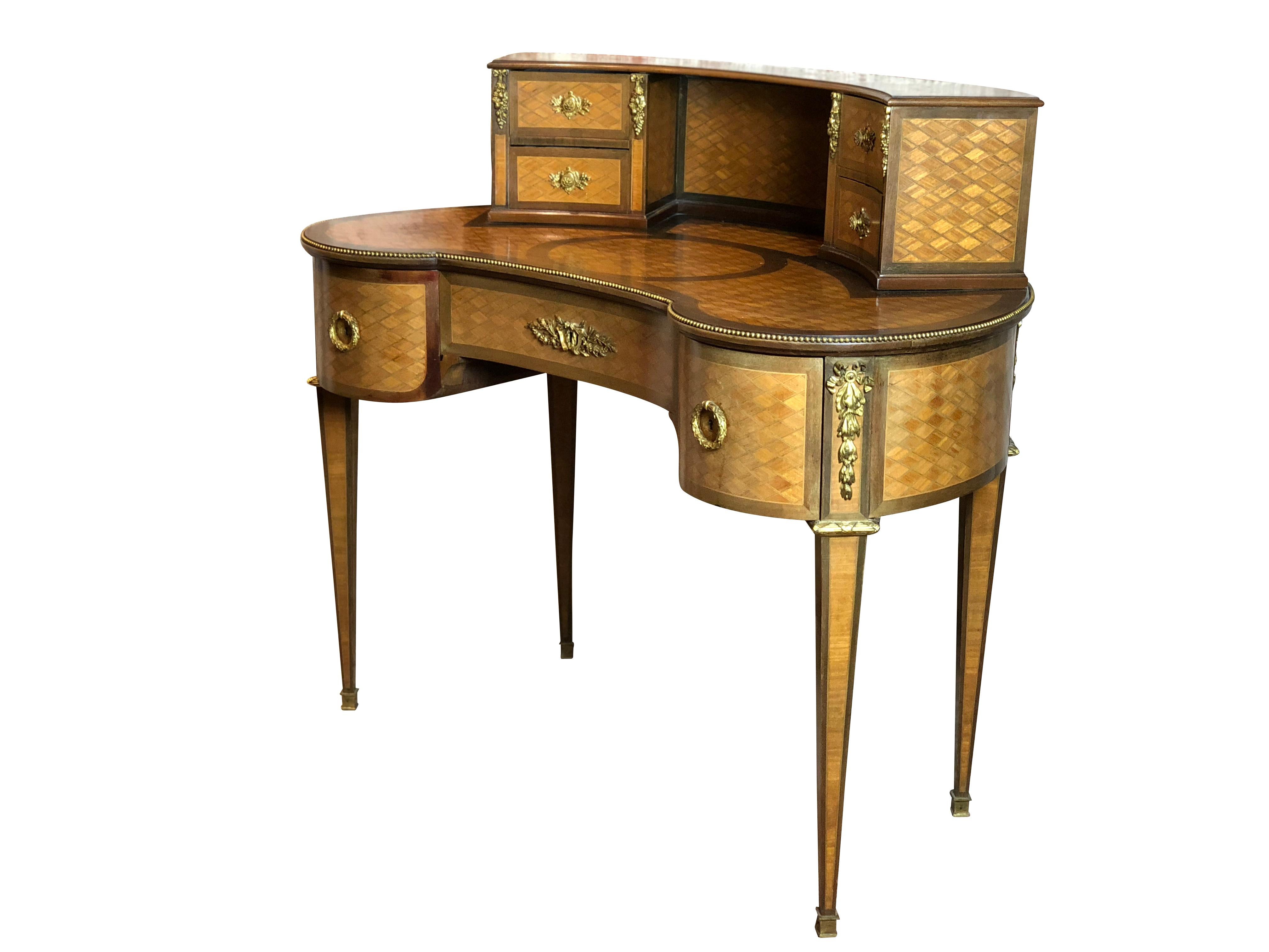 A charming 19th century French Louis XVI style gilt bronze-mounted kidney shaped and parquetry inlaid desk

France, circa 1890

Having Seven-drawers with the original key, over Louis XVI style shaped legs with gilt bronze mounts. The top