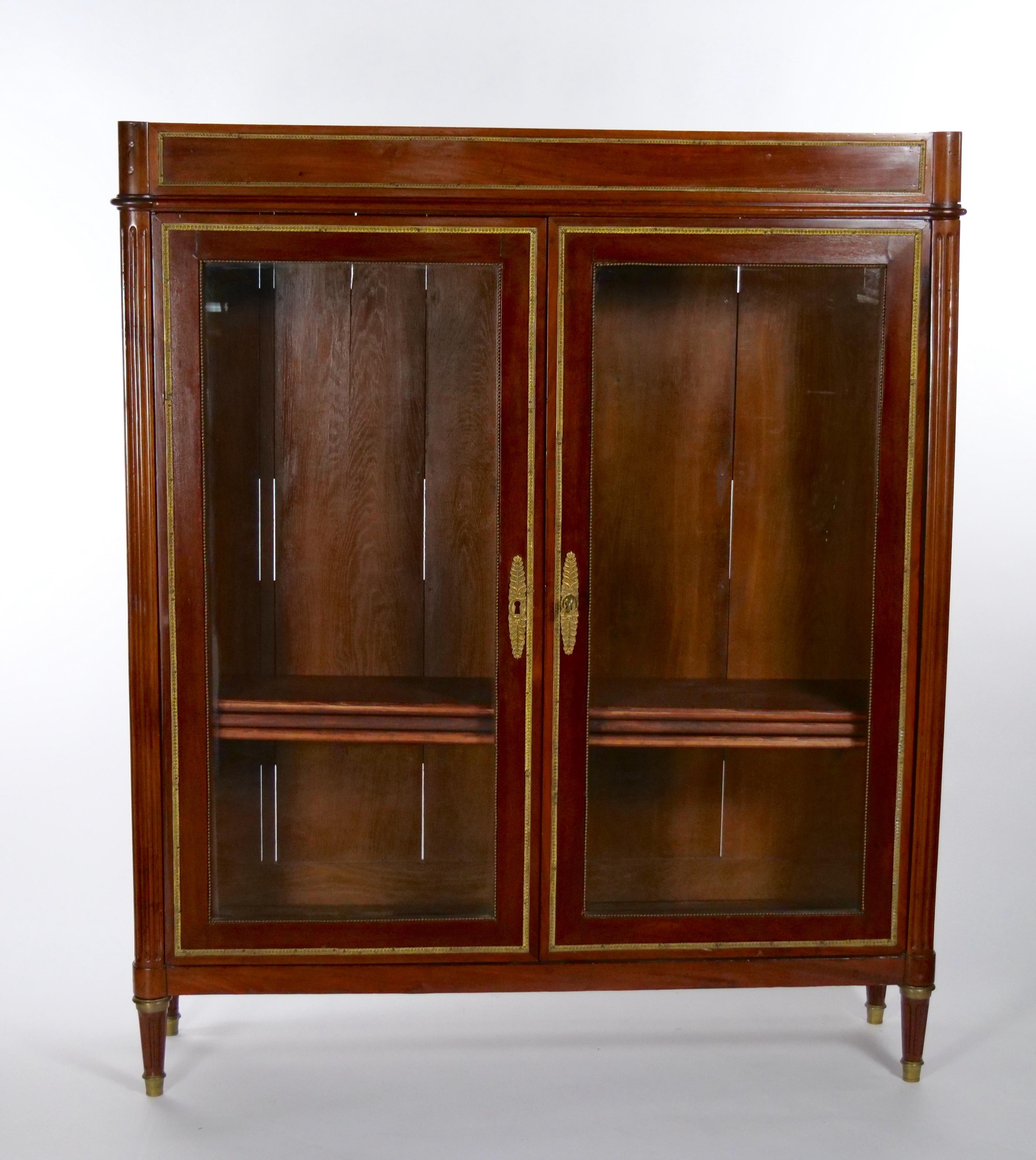 Early 19th century French Louis XVI style Mahogany with brass mounted marble top vitrine / bookcase. This was designed to display your most prized possessions or one of a kind collection with incredible style. Beautifully Crafted from exotic