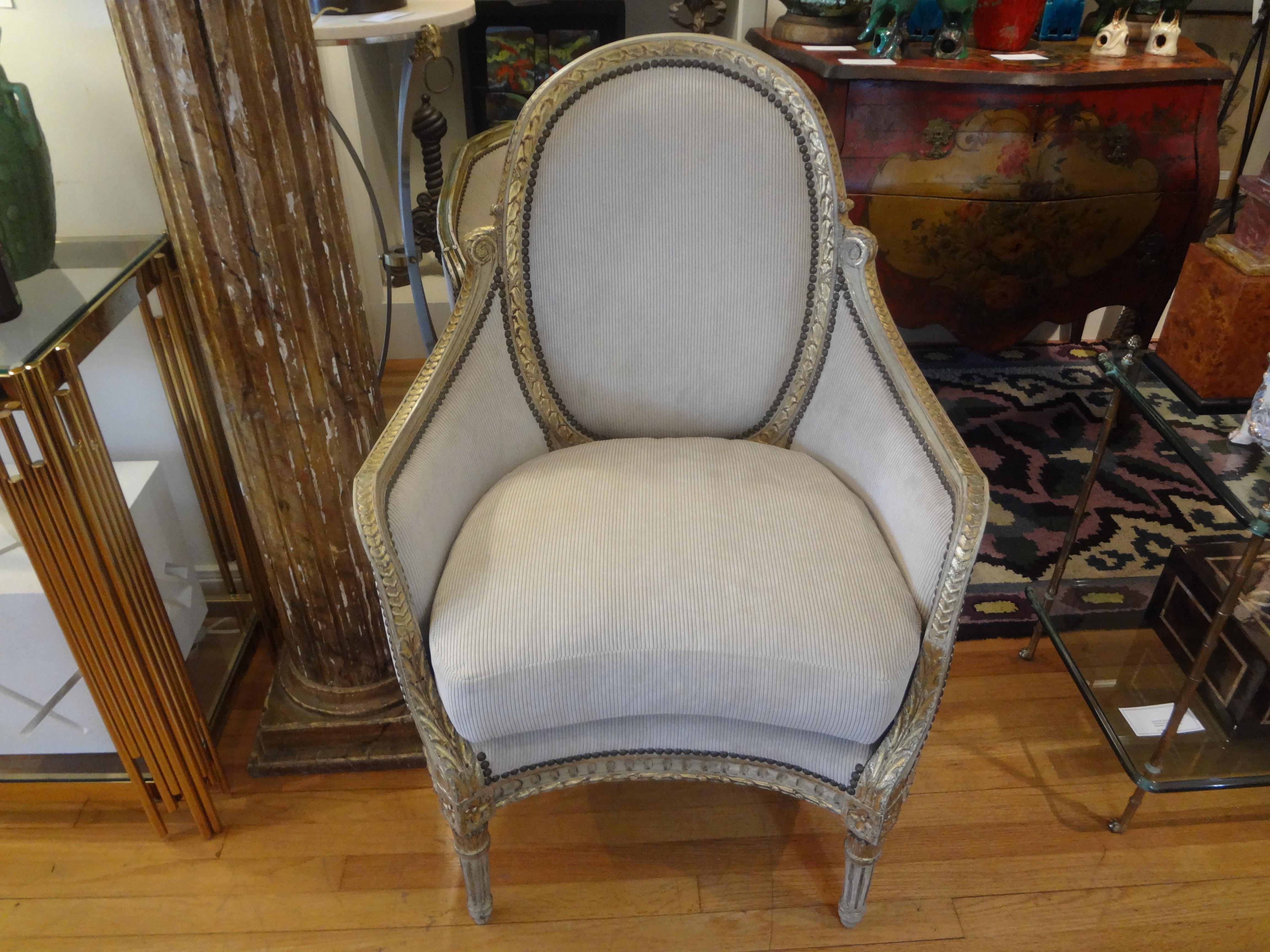 Stunning 19th century French Louis XVI style painted and parcel-gilt bergère. This most comfortable chair has been professionally upholstered in a plush light beige striated cut velvet fabric with a down cushion. Gorgeous from every angle.