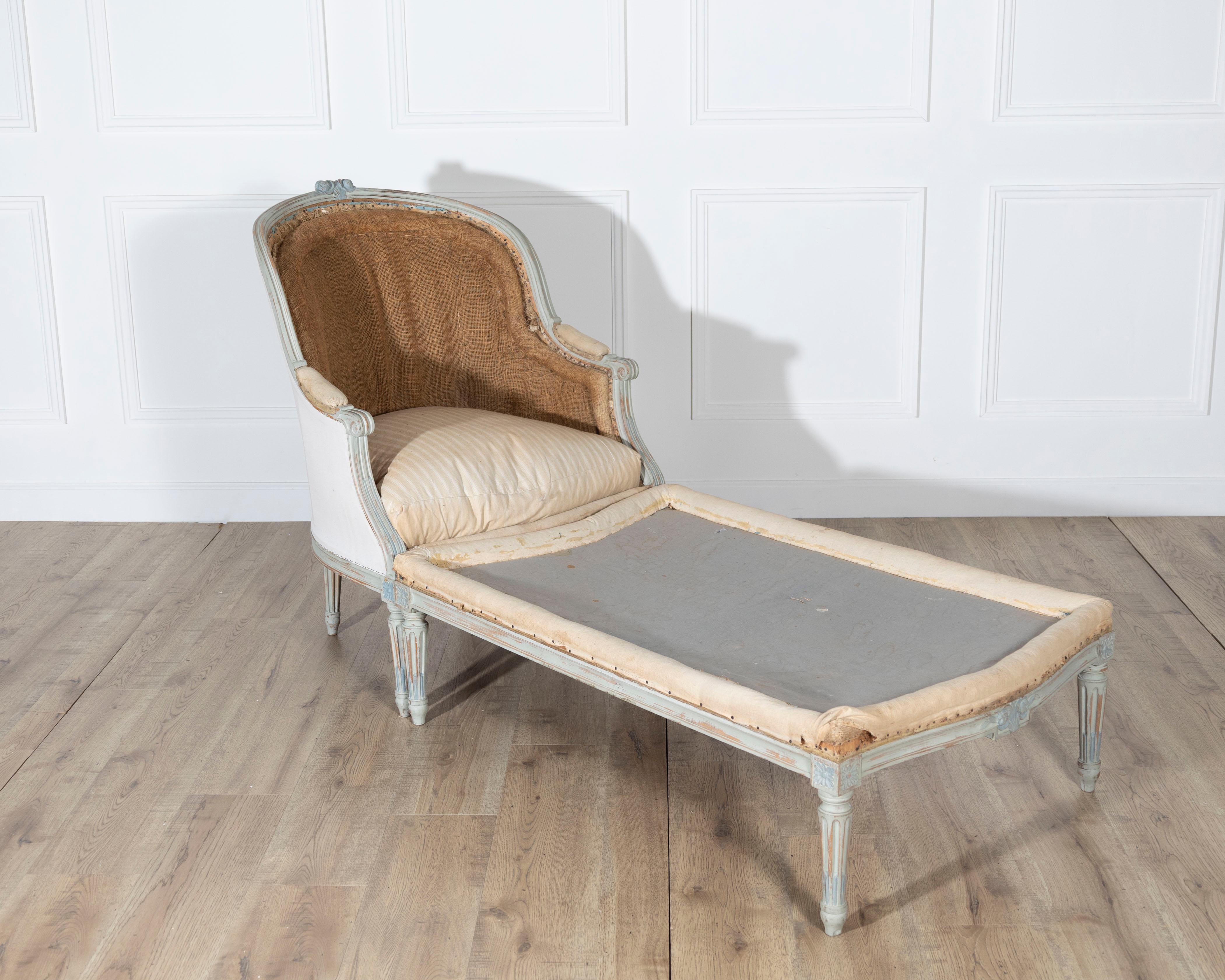 A graceful French lie de repos from the second half of the 19th century, crafted in the Louis XVI style with elegant neoclassical details. The carved beechwood frame retains its original painted finish, now beautifully worn to a soft blue-gray