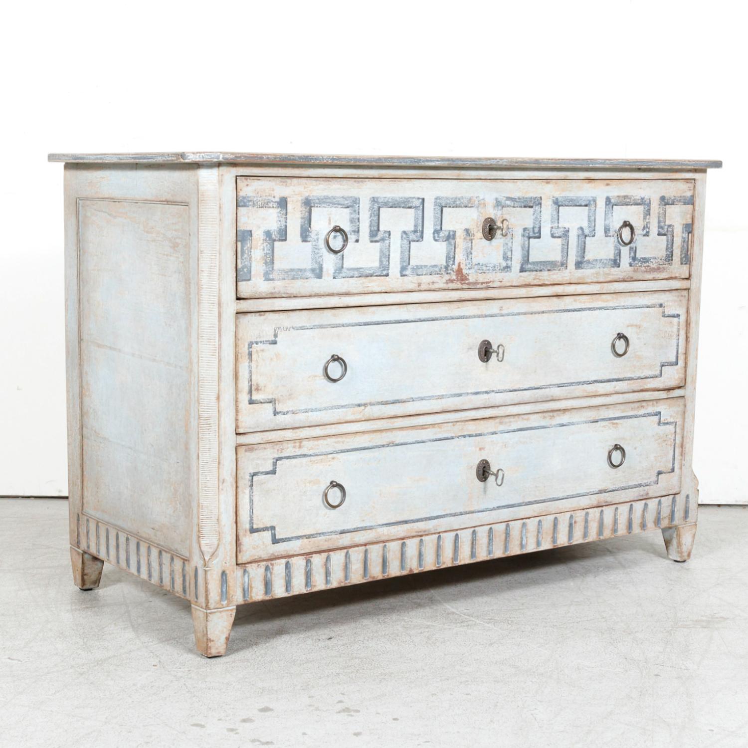A handsome 19th century French Louis XVI style painted three-drawer commode handcrafted in the South of France near Avignon, circa 1890s. Having a beautifully distressed bluish-gray painted finish, this handsome French chest of drawers features a