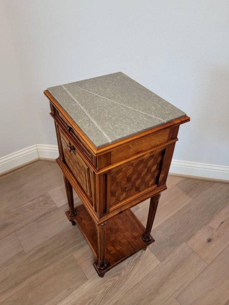 A French carved walnut bedside table with beautiful rich coloring and nicely aged patina. 

Born in France, most likely Parisian work, dating to the third quarter of the nineteenth century, Napoleon III Second Empire Period, excellent quality
