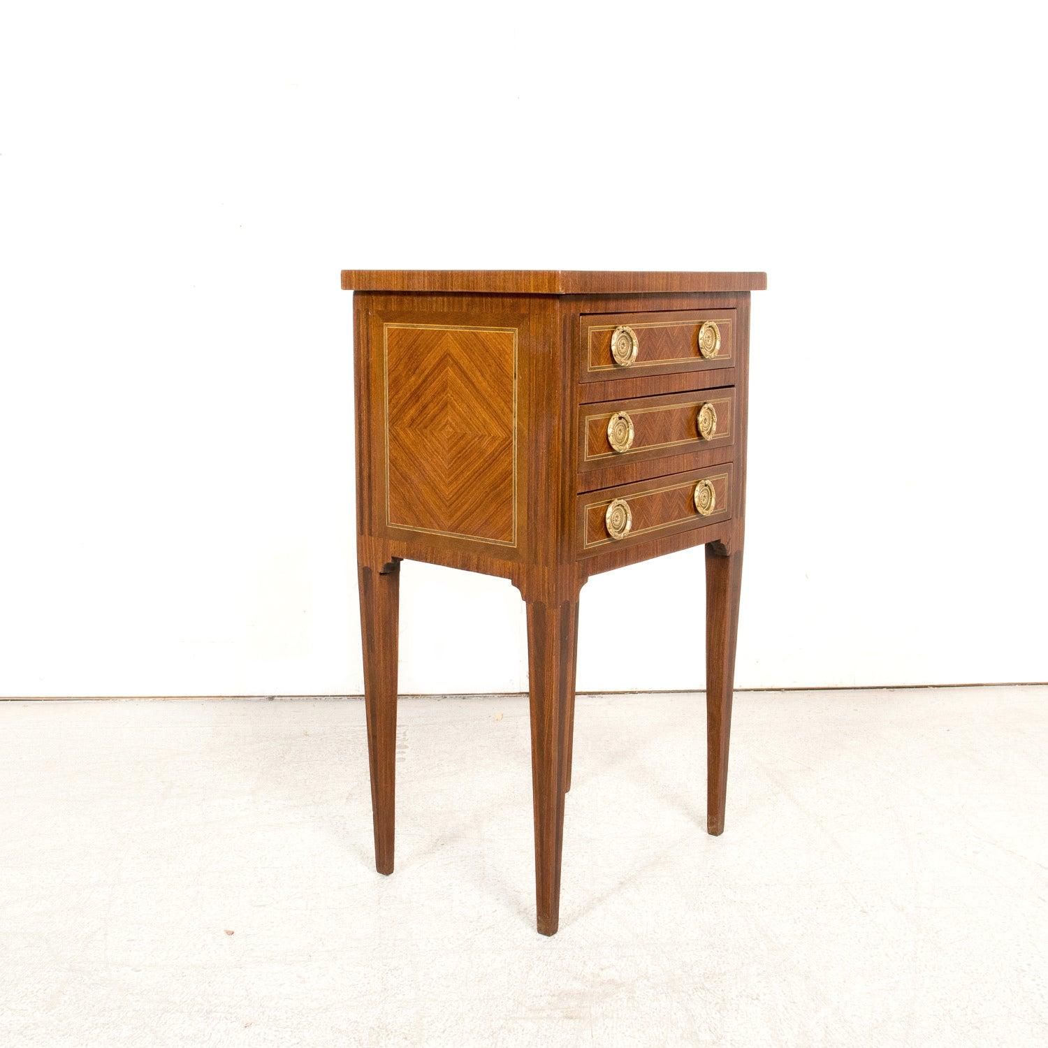 A beautifully handcrafted 19th century French commode or side table from the historic Provençal city of Arles. Petite in scale but rich in detail, this elegant piece is constructed of solid walnut and features intricate fruitwood and tulipwood