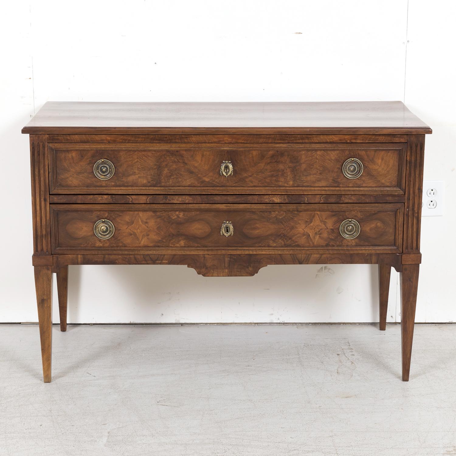 A striking 19th century French Louis XVI style commode sauteuse handcrafted of walnut with burled walnut drawers by talented artisans in the South of France near the hilltop town of Carcassonne, circa 1880s, having a rectangular plank top sitting