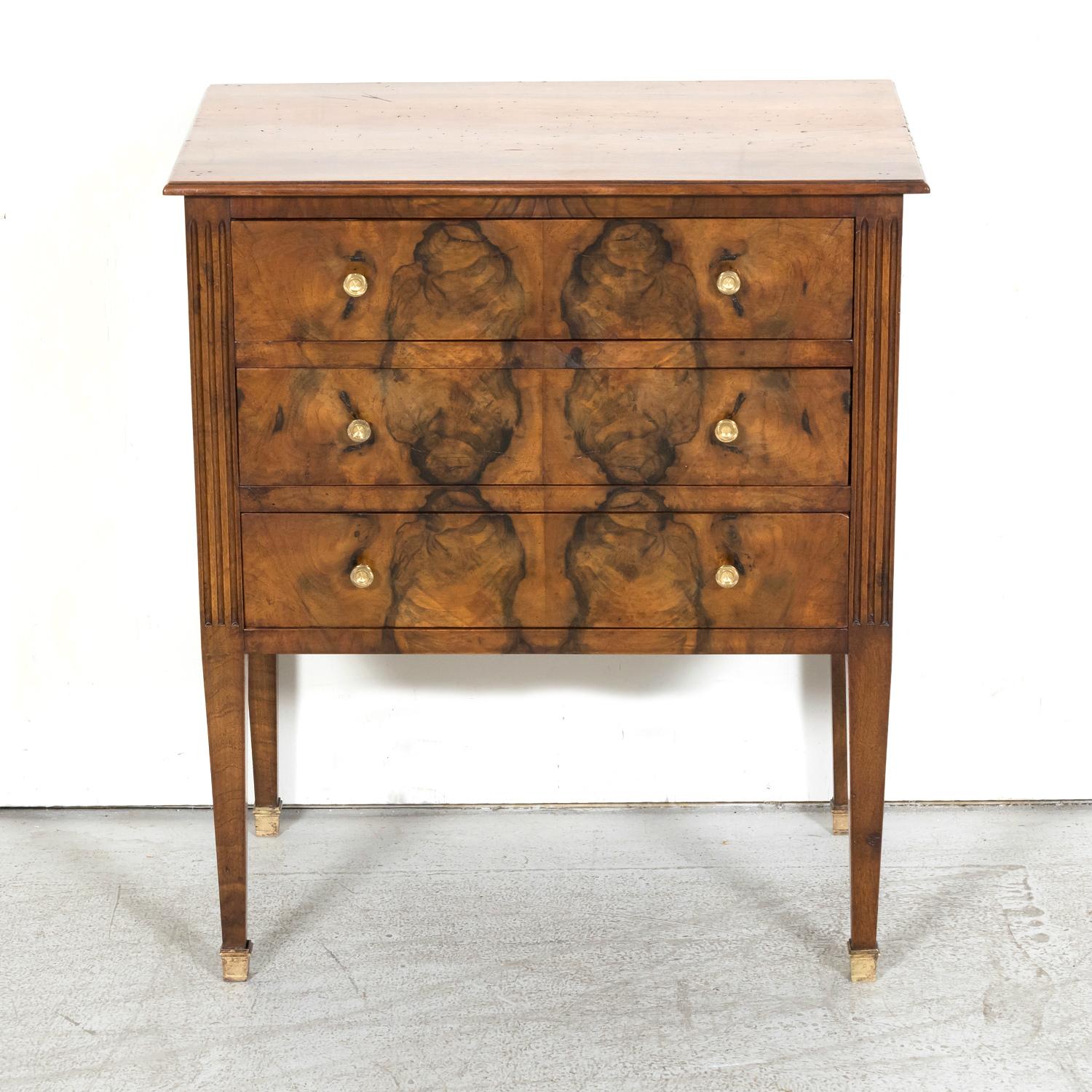 A handsome 19th century French Louis XVI style three-drawer petite commode, circa 1890s, from the port city of Bordeaux, known the world over for its wine. This antique French chest of drawers is handcrafted of meticulously bookmatched walnut and