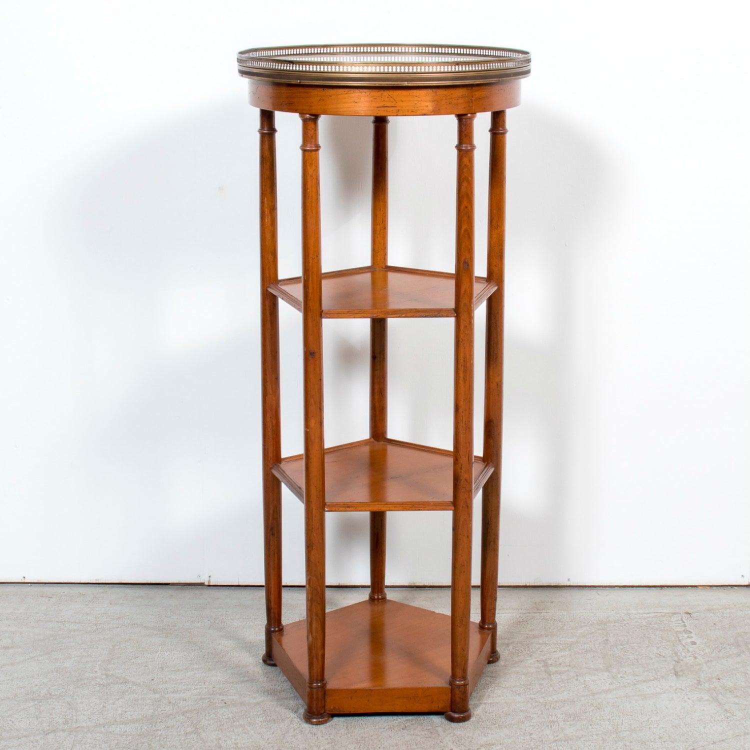 A refined Louis XVI style dessert or display stand handcrafted of walnut by talented artisans in Bordeaux, circa 1890s. This elegant piece features a round white Carrara marble top surrounded by a finely detailed pierced brass gallery, adding both