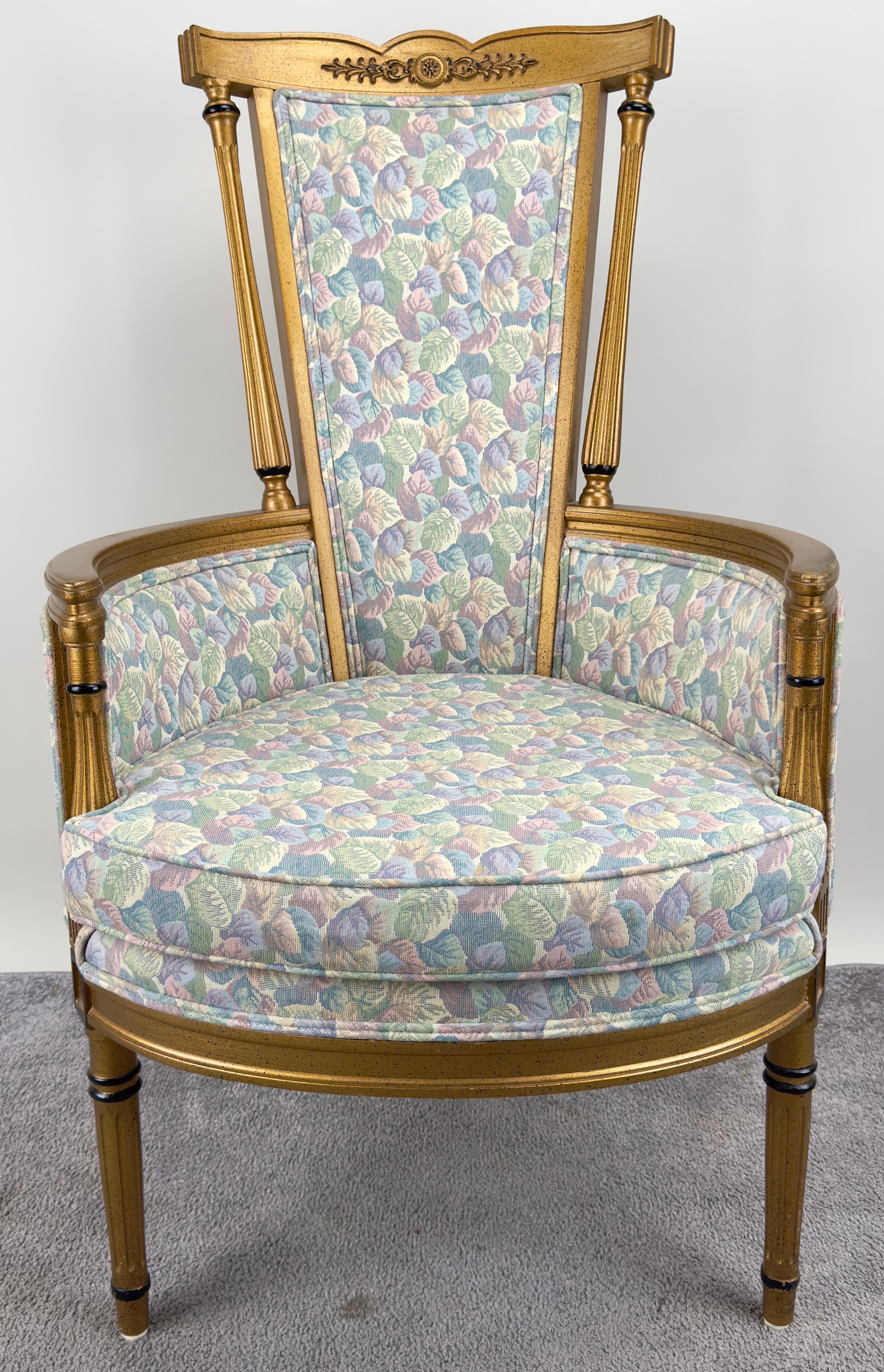 A 19th-century French Louis XVI style Wingback chair crafted in the classic neoclassical elegance. The chair features a high, winged backrest that gently curves, providing both aesthetic appeal and support. Its frame is a soft light brown tone,