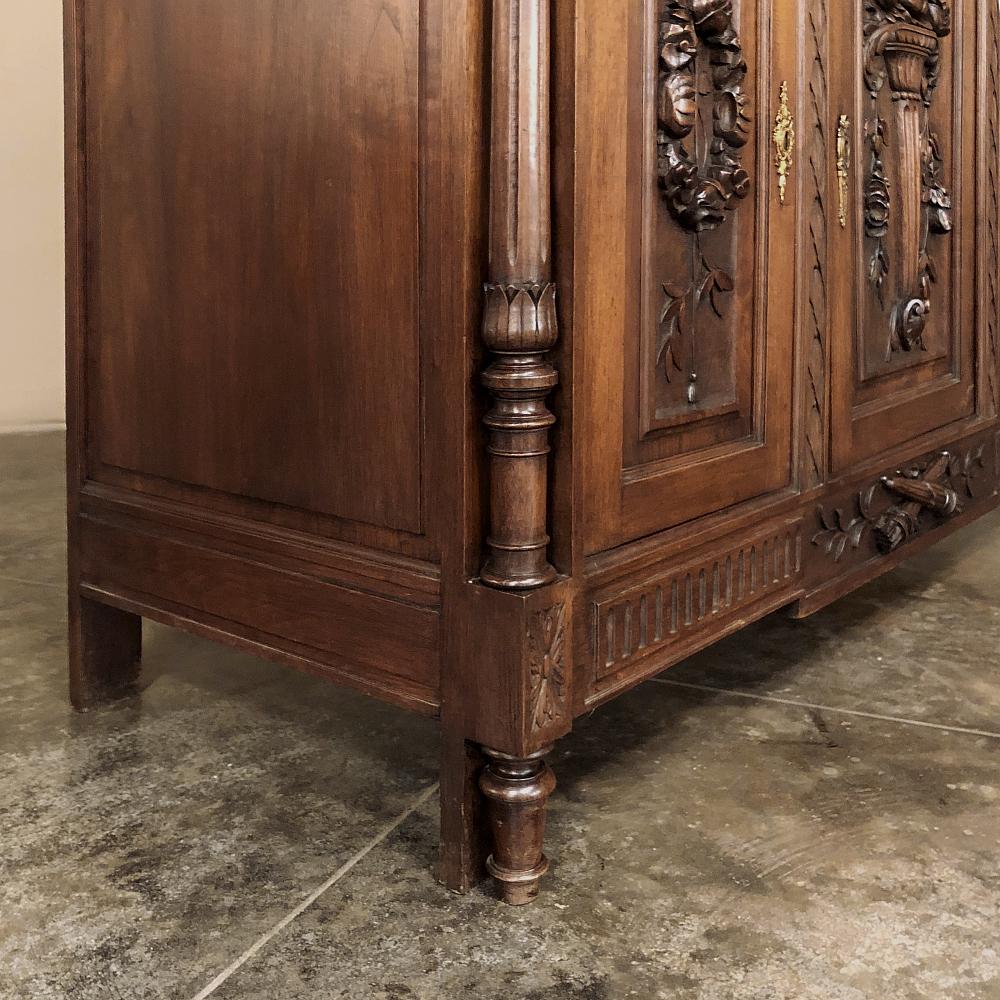 19th century French Louis XVI walnut buffet is a glorious testament to the artistic talents of the sculptors who created such visual magnificence out of sumptuous French walnut! Set upon a classically-inspired architectural form, the piece features