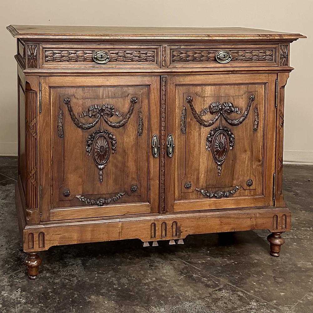 19th Century French Louis XVI Walnut Buffet ~ Sideboard is a marvelous testament to the talents of true artists in the world of cabinetmaking!  Hand-crafted from sumptuous French walnut, it features a solid plank beveled top over a drawer tier