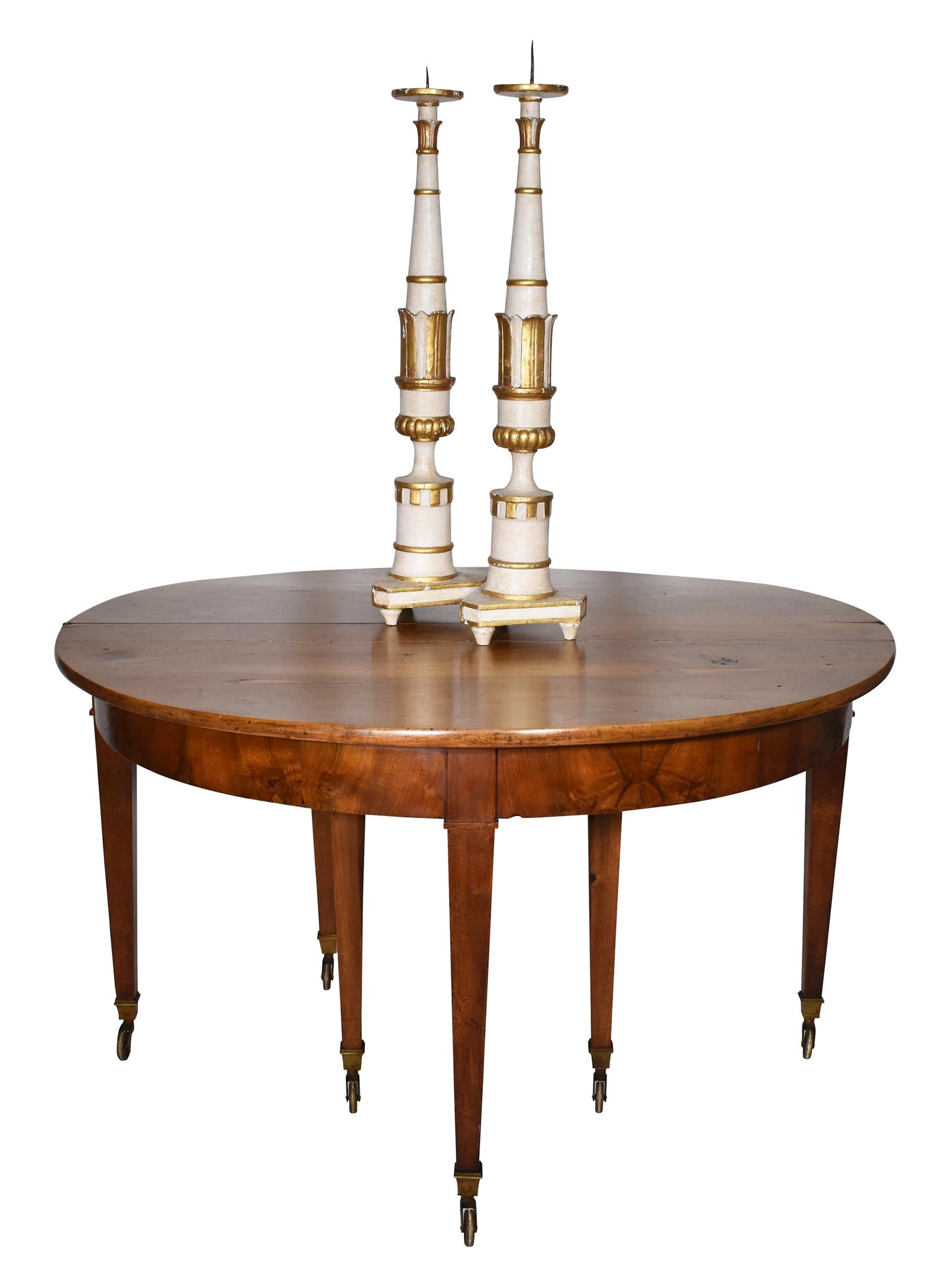 Walnut 19th Century Louis XVI Dining Table with straight tapering legs and brass casters. The table expands to accept leaves for formal dining.