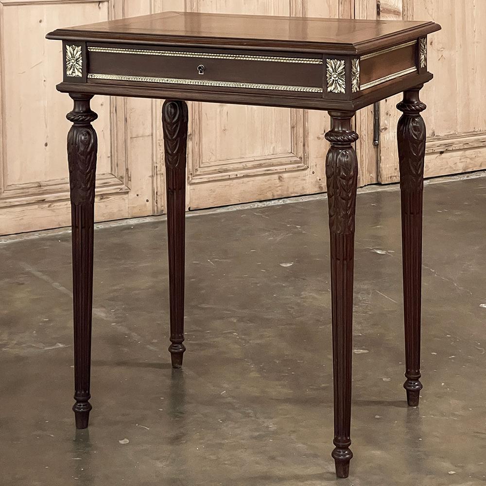 19th Century French Louis XVI Walnut End Table with Bronze Mounts is obviously a product of superior craftsmanship melded with the finest materials to create a timeless example of the furniture maker's art.  The sumptuous grain and rich coloration