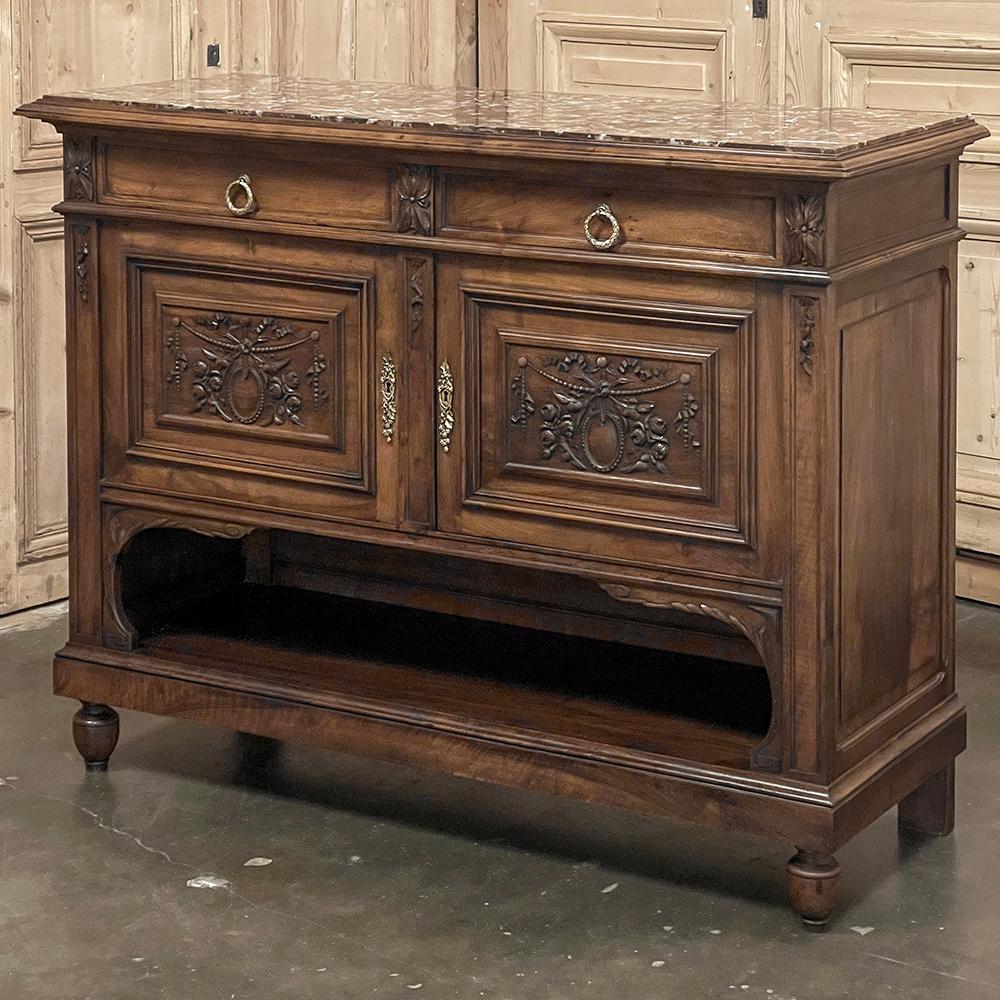 19th Century French Louis XVI Walnut Marble Top Buffet makes an excellent choice for any room!  Sculpted from sumptuous French walnut, it features a classical architecture that literally defies time itself.  A richly veined marble top provides a