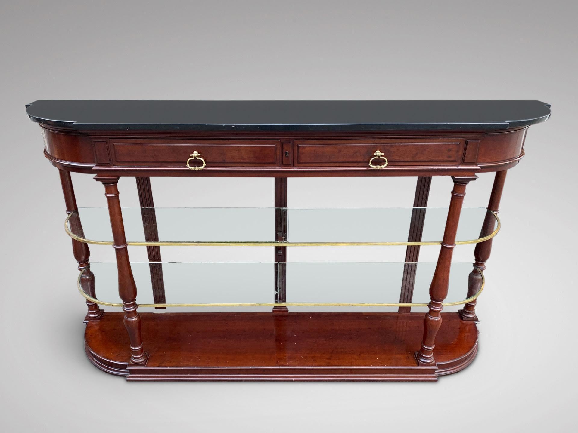 A 19th century French mahogany console table or sideboard with shaped black marble top above a pair of drawers with working lock, two glass shelves with brass fittings, supported by four turned supports, all standing on a plinth base. Great looking