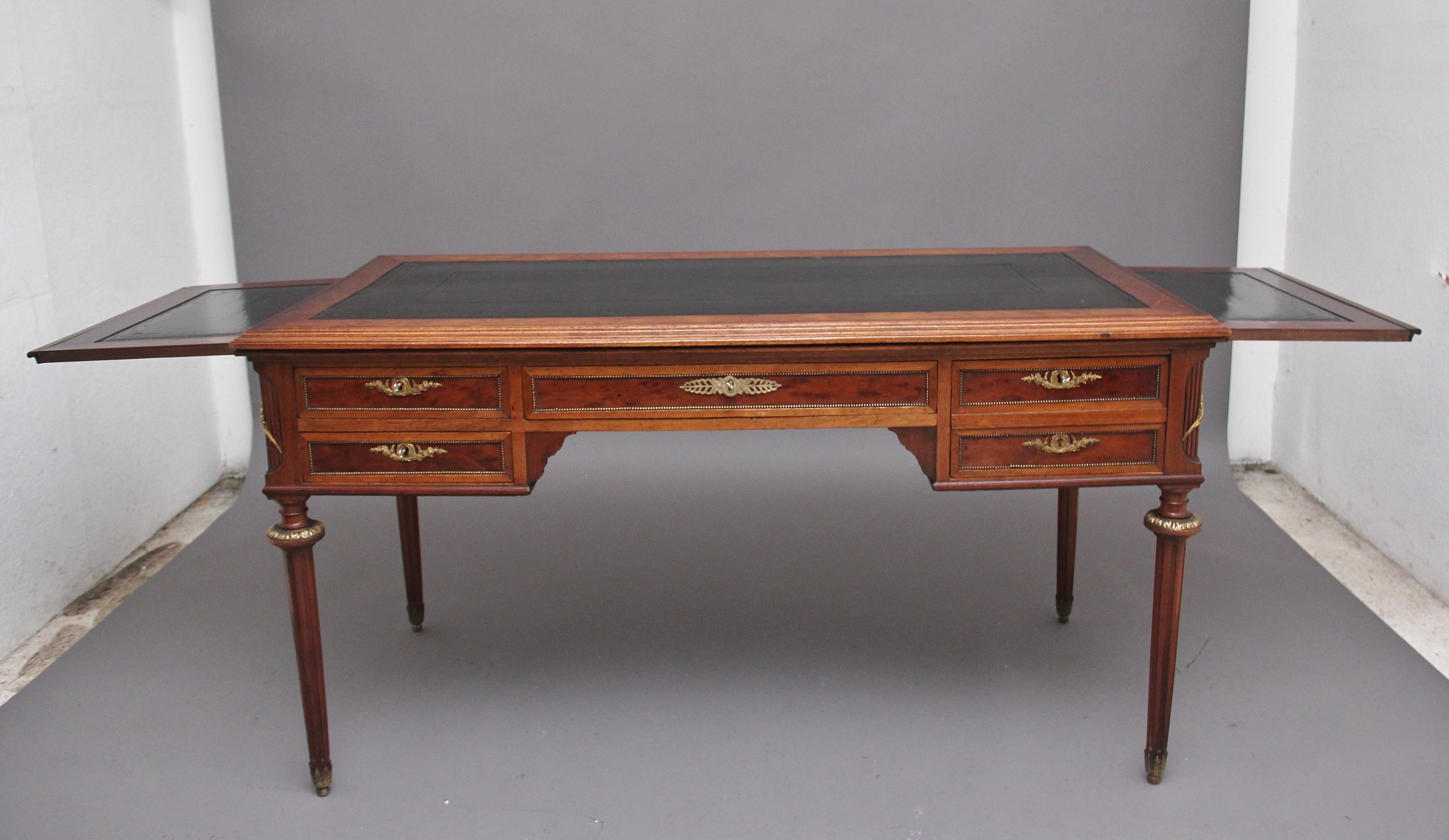 19th Century French mahogany directoire writing desk, the moulded edge top having a green leather writing surface decorated with blind and gilt tooling, the edge of the top having ebony inlay, pull out slides either side incorporating the same style