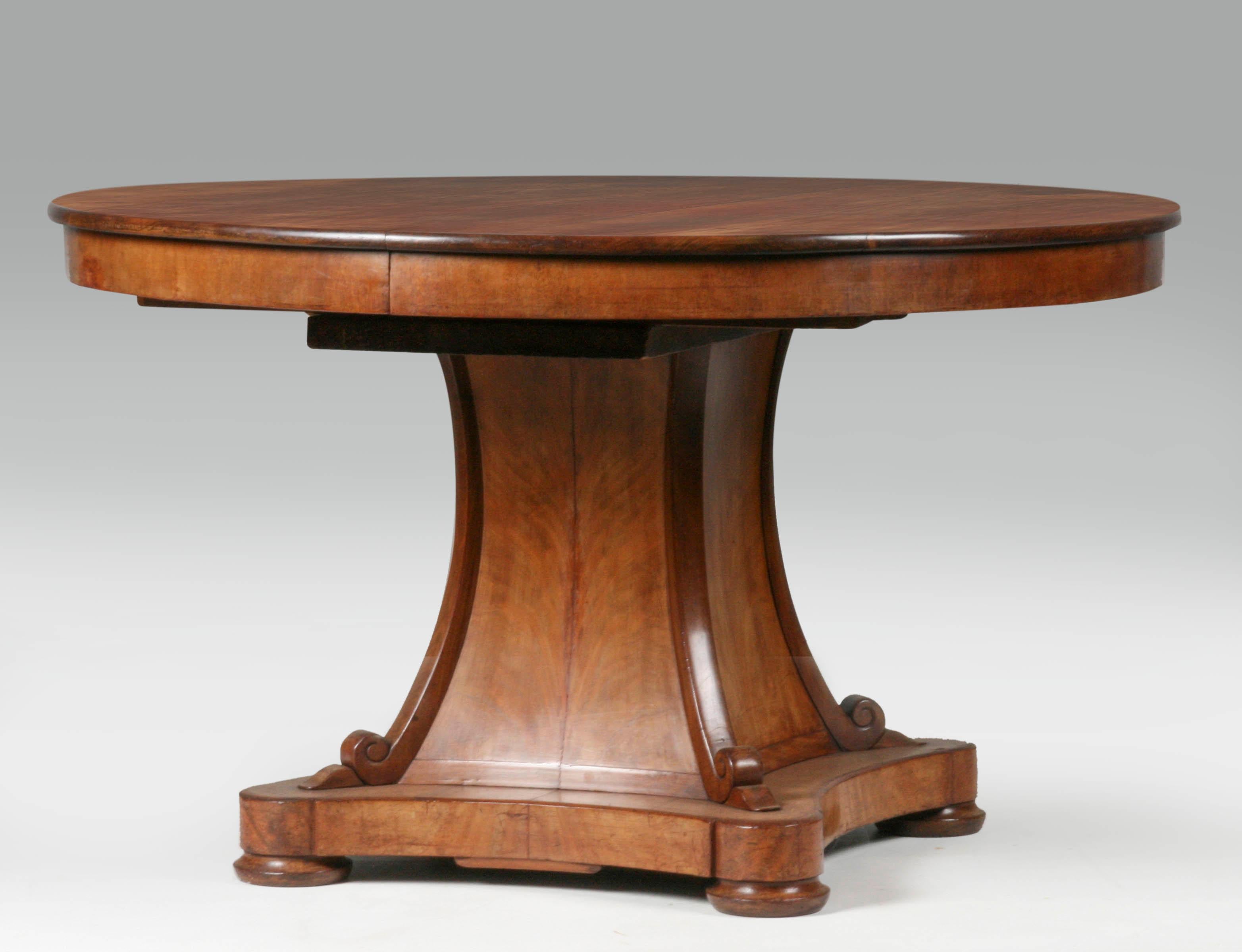 Round dining room table. Book matches mahogany veneered tabletop and base. This is a 