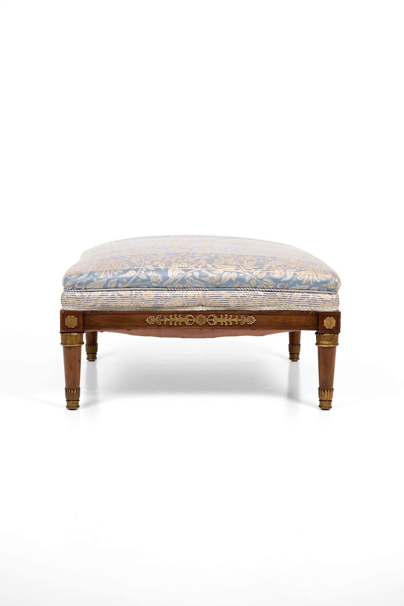 A large and simply stunning 19th Century French footstool. Made in mahogany with delicate Ormolu mounts to legs ending in square tapering supports. The gently bowed sides are topped with a finely patterned Damask fabric. 
France, circa