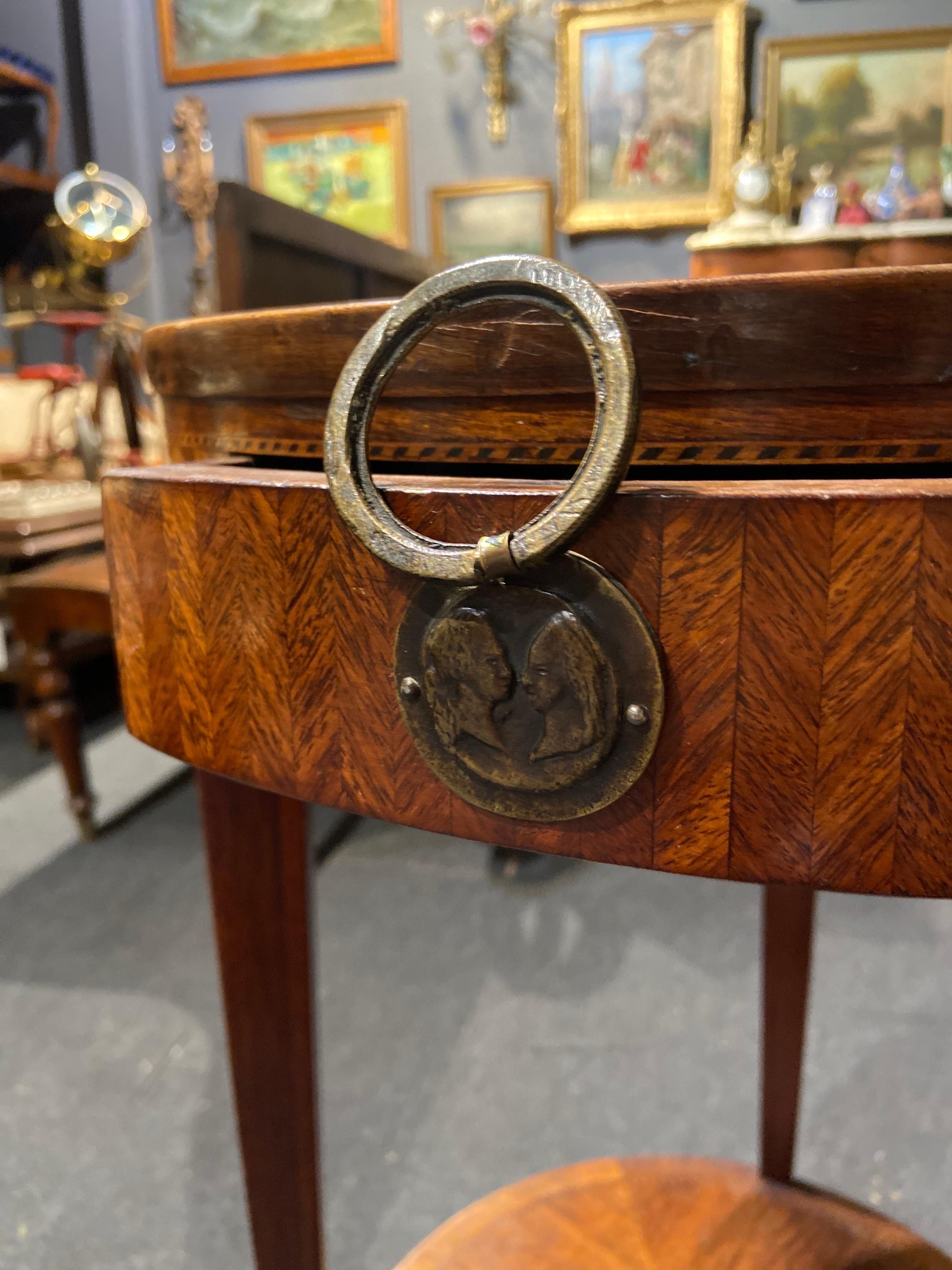 Beautiful French mahogany inlaid round side table in Louis XVI style made in late 19th Century. There is one front drawer and a lower shelf. The piece is inlaid on the top and all around and is in quite good condition having in mind the age and