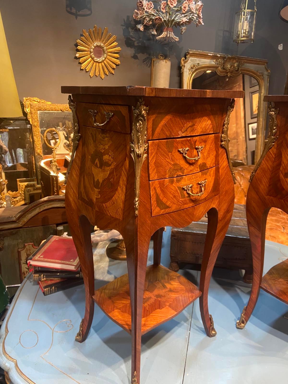 A beautiful French mahogany inlaid side table in Louis XVI style made in late 19th Century. It is raised on four elegant feet ending with bronze decoration with two front drawers and a third one on the side and there is a shelf at the bottom. The