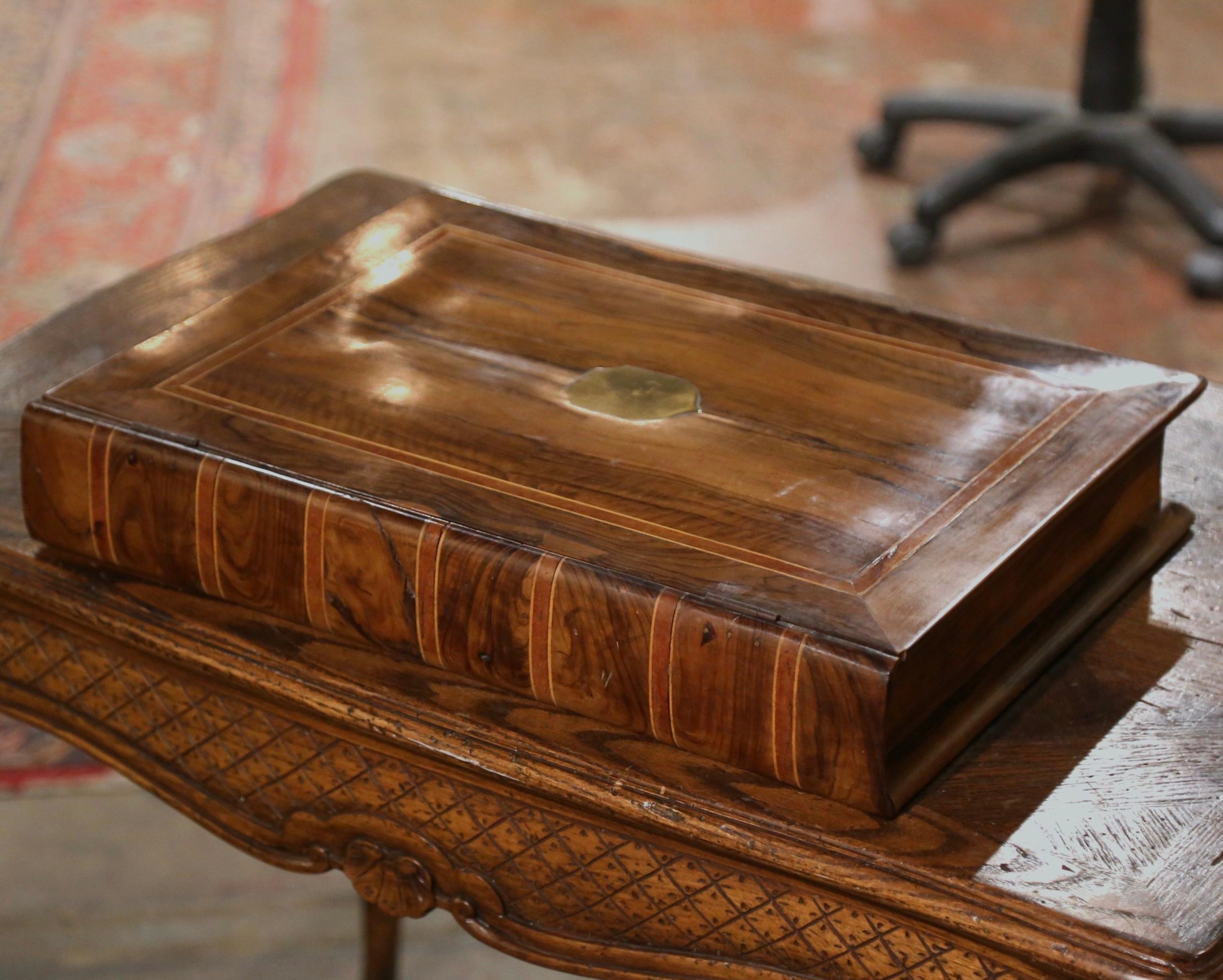 Store your TV remote controls or other valuables in this antique “Trompe l’œil” box. Created in France circa 1880 and built of mahogany wood, the Bible book storage box, now fashioned as a table box is decorated with marquetry band, and embellished