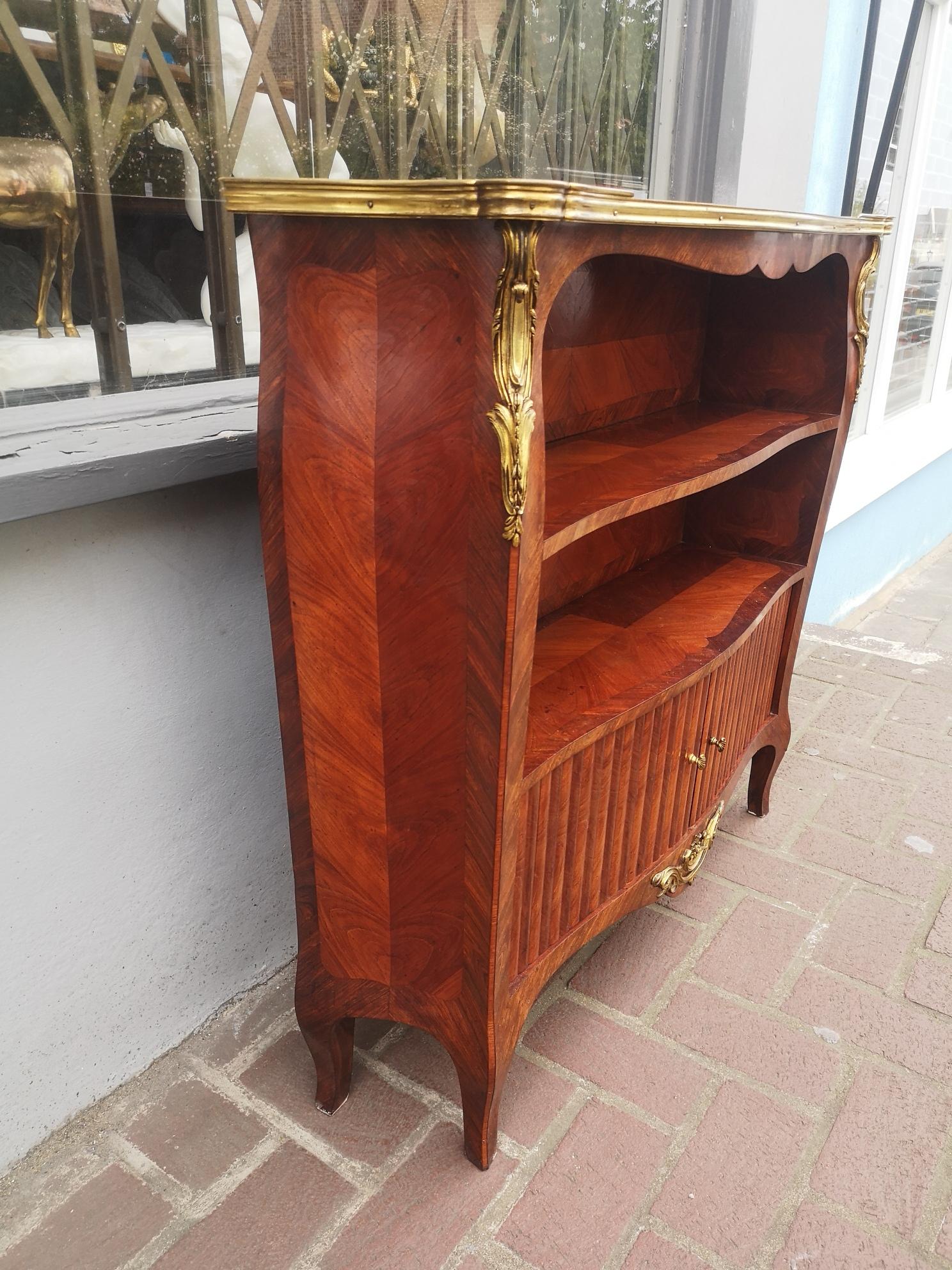 A good quality 19th century French mahogany bookcase, with two open shelves and a sliding tambour cupboard and bronze mounts. Of useful slender proportions.
Made by L'Escalier de crystal, a Parisian shop founded in 1804 and specialising in high end