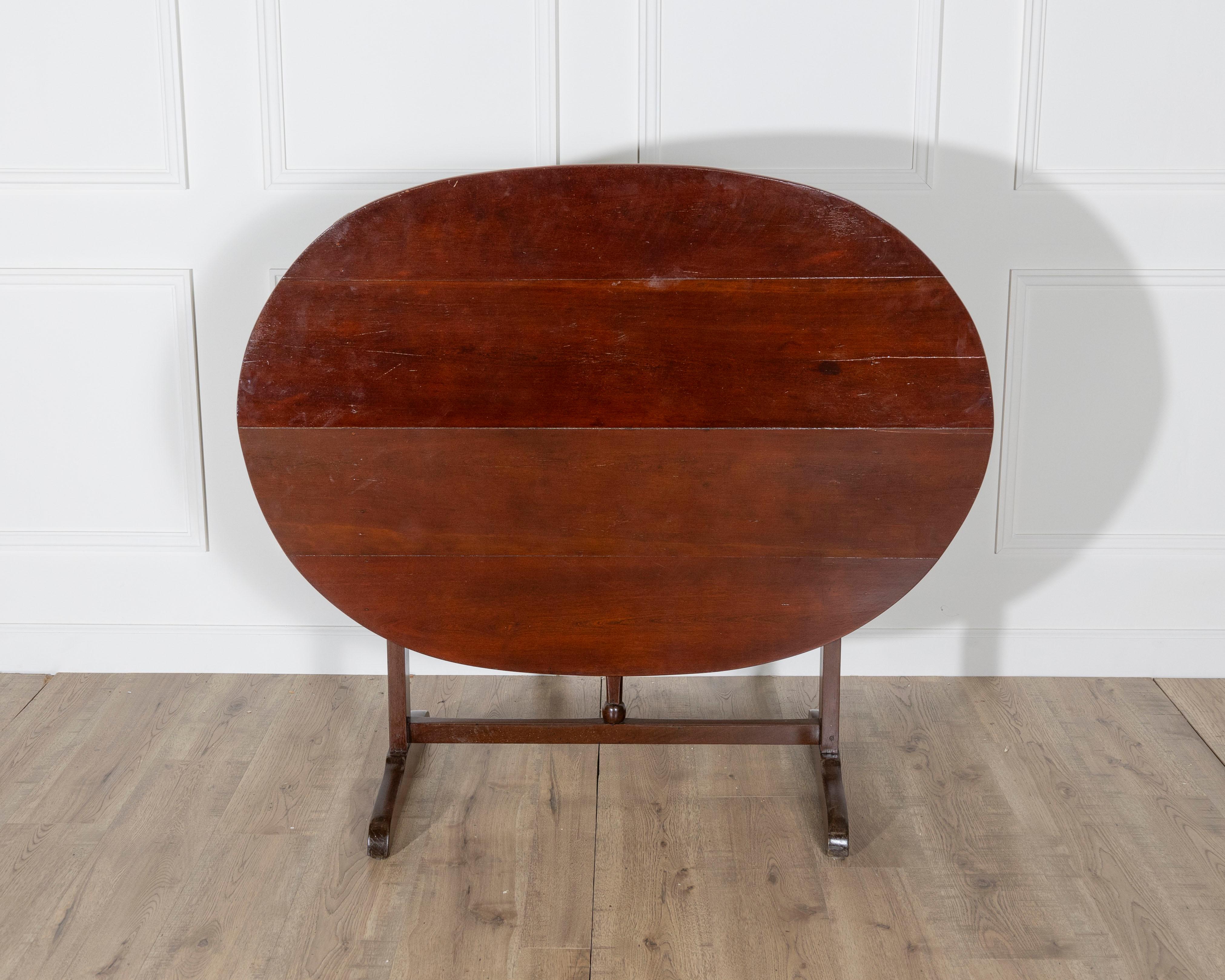A classic 19th century French winegrower’s table, originating from the Burgundy region and crafted in richly toned mahogany. This traditional oval tilt-top table, known locally as a table de vigneron, was originally used by vintners for tastings and