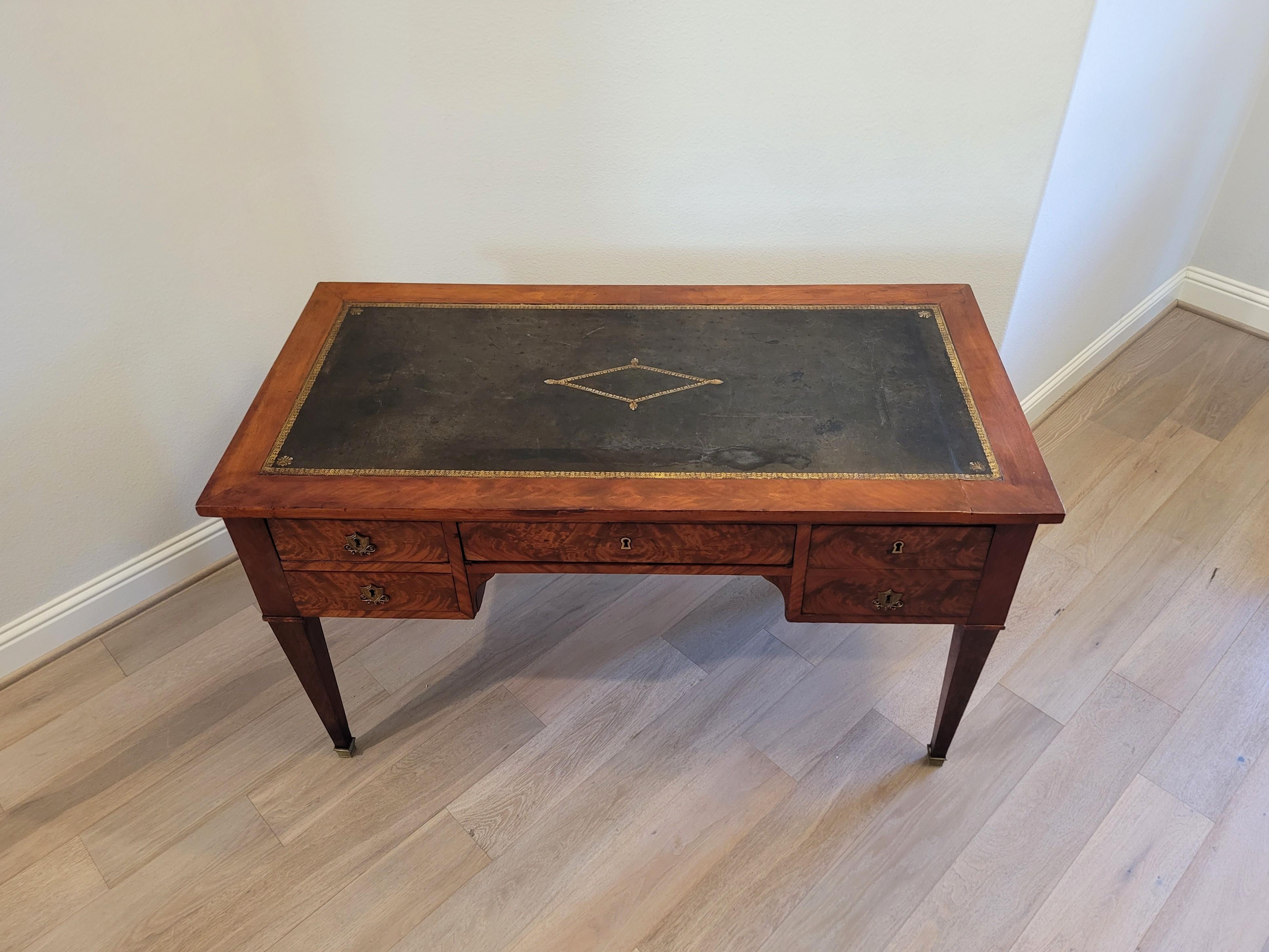 A handsome nearly 200 year old French Restoration (1815-1830) / Louis Philippe (1830-1848) Period mahogany bureau plat with beautifully aged patina.

Born in France during the first half of the 19th century, hand-crafted of warm rich solid