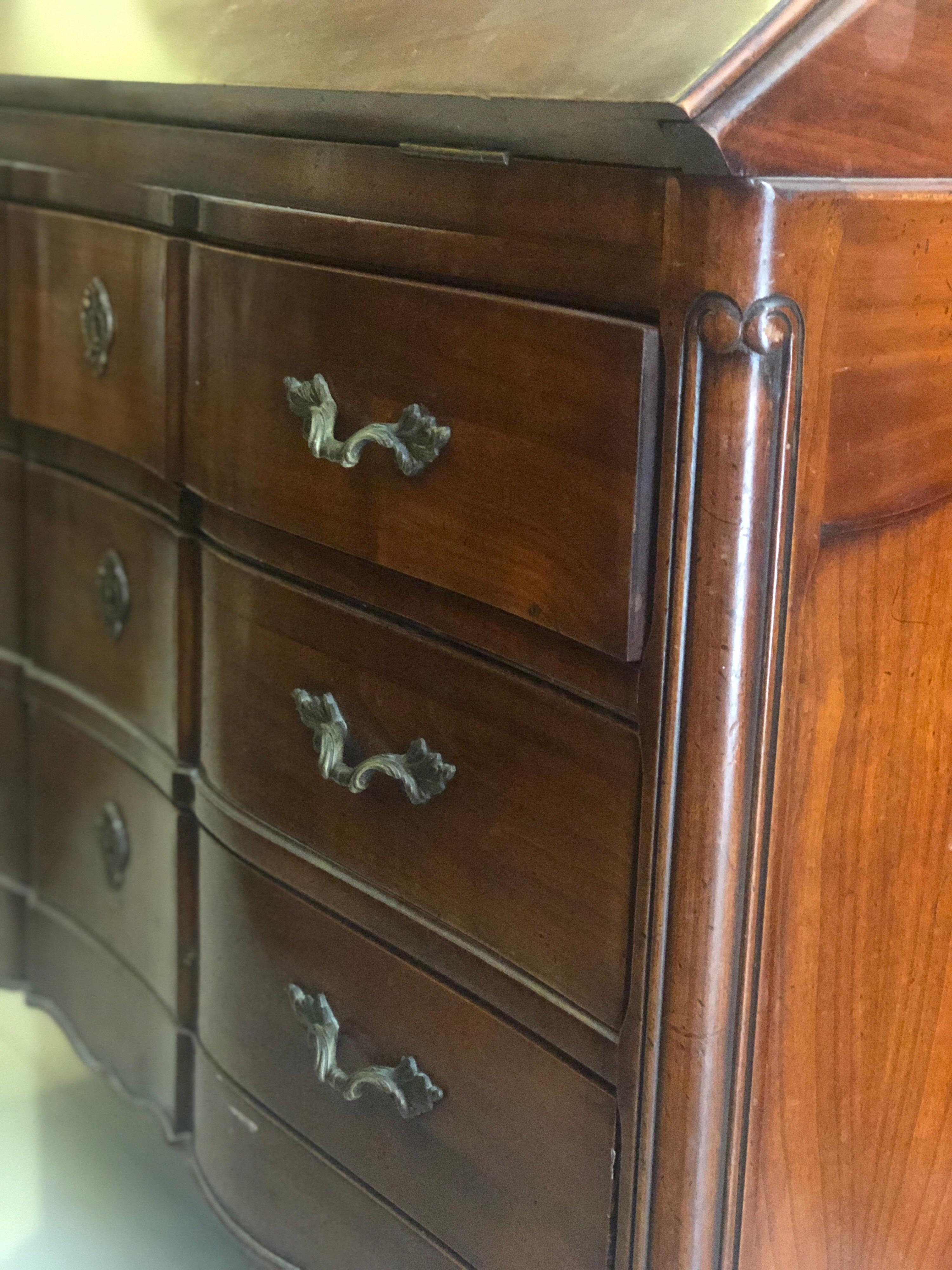 French mahogany writing desk with folding front part and hidden drawers in the upper part. There are also three big drawers in the lower part. Very good condition and original key.
France, circa 1900.