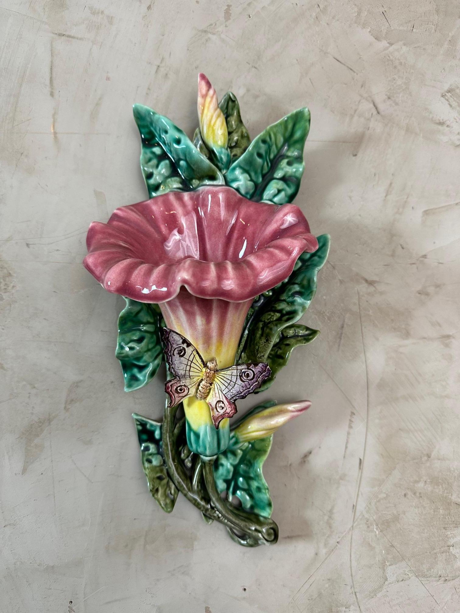 A beautiful late 19th-century glazed Majolica flower and butterfly wall pocket depicting a large, dark pink Morning Glory Convolvulus flower in full bloom.
On the front is a butterfly (one wingtip is broken off), supported by plump green leaves.
The
