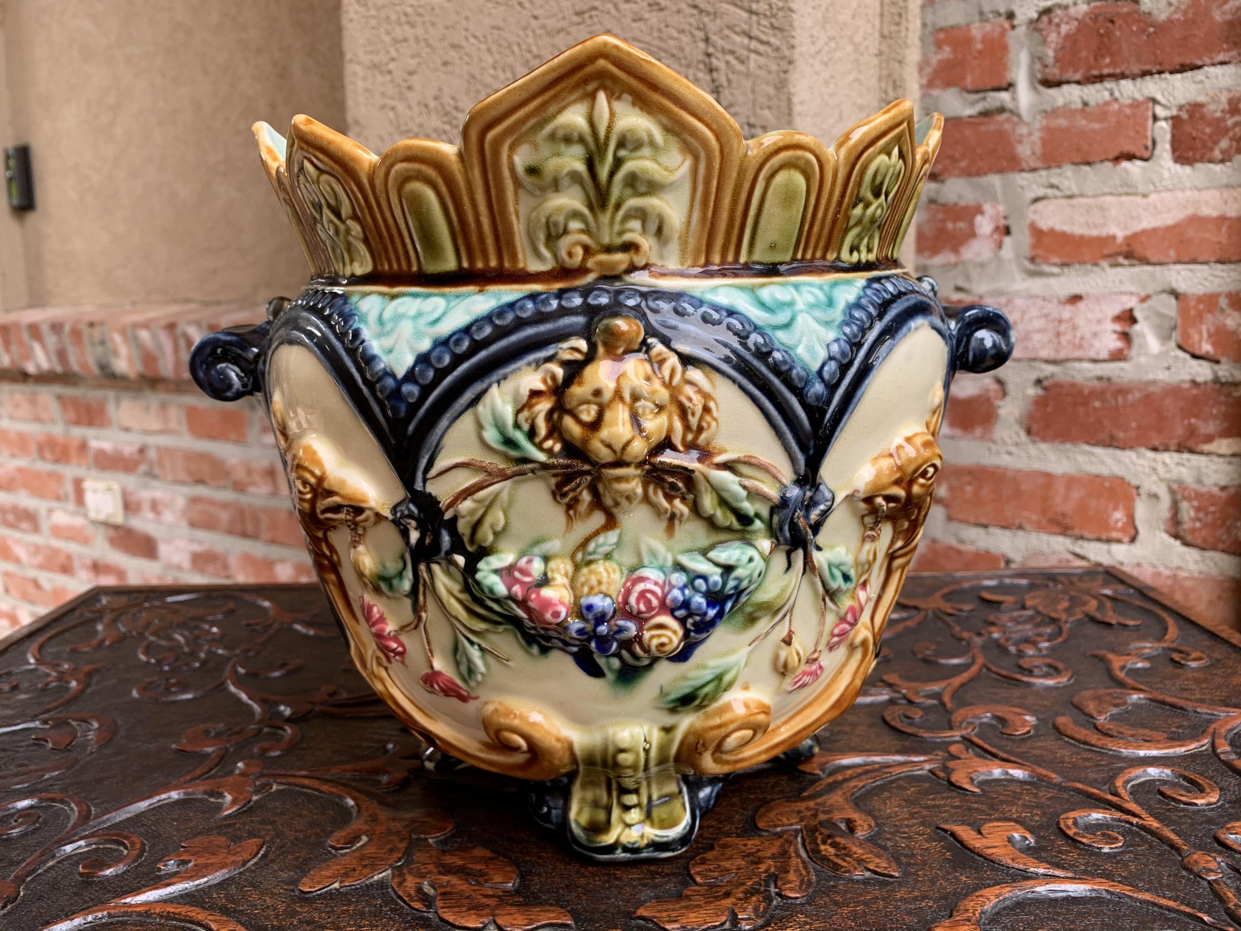 19th century French Majolica cache pot planter jardinière lion onnaing barbotine

~Direct from France~
A gorgeous antique French barbotine cache pot.
~Stunning design features a lion head over floral swag, with bird holding twigs in mouth on either