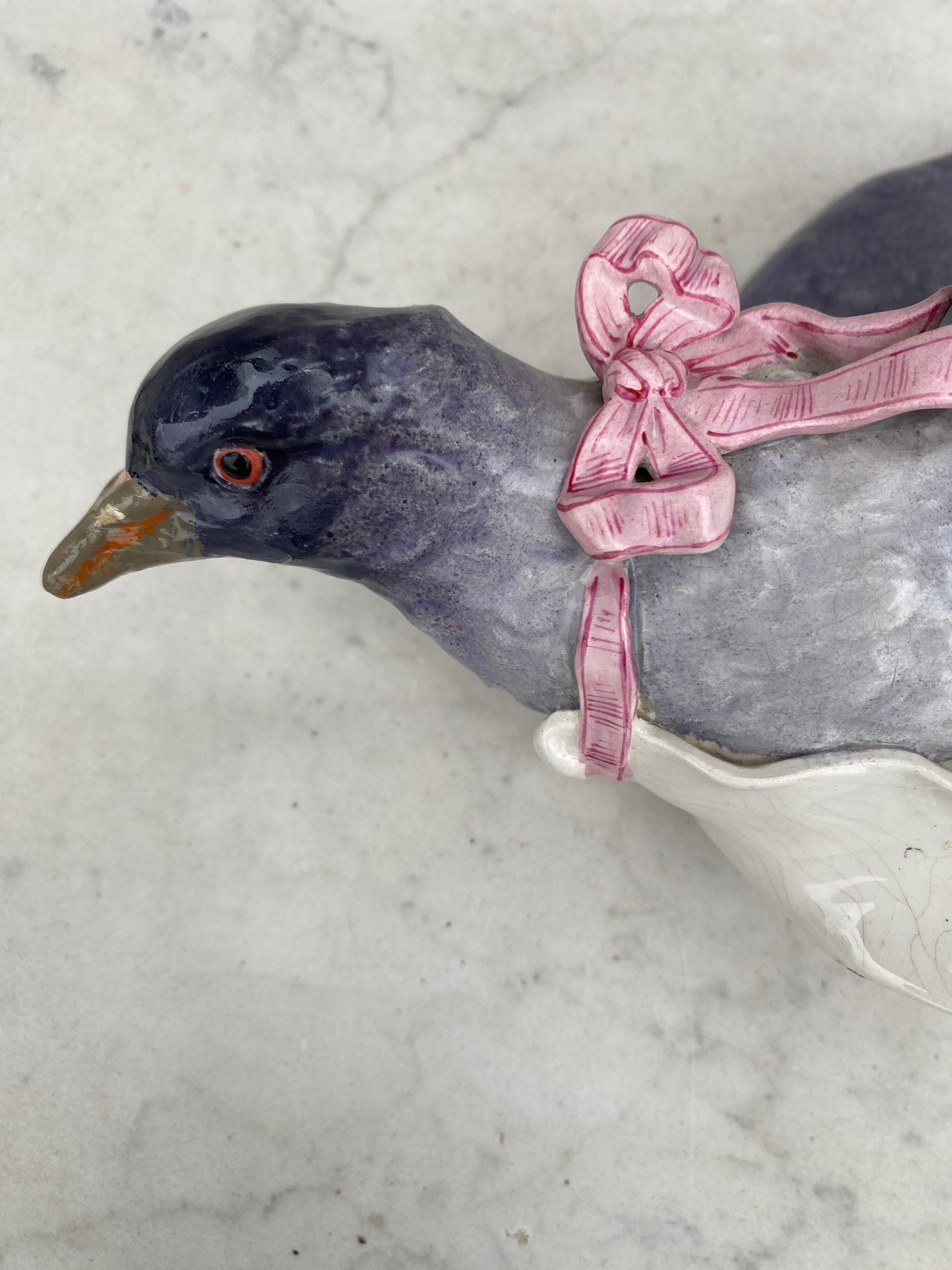 Large 19th century French Majolica Pigeon wall pocket.
The pigeon have a pink ribbon and carry a white card.
 