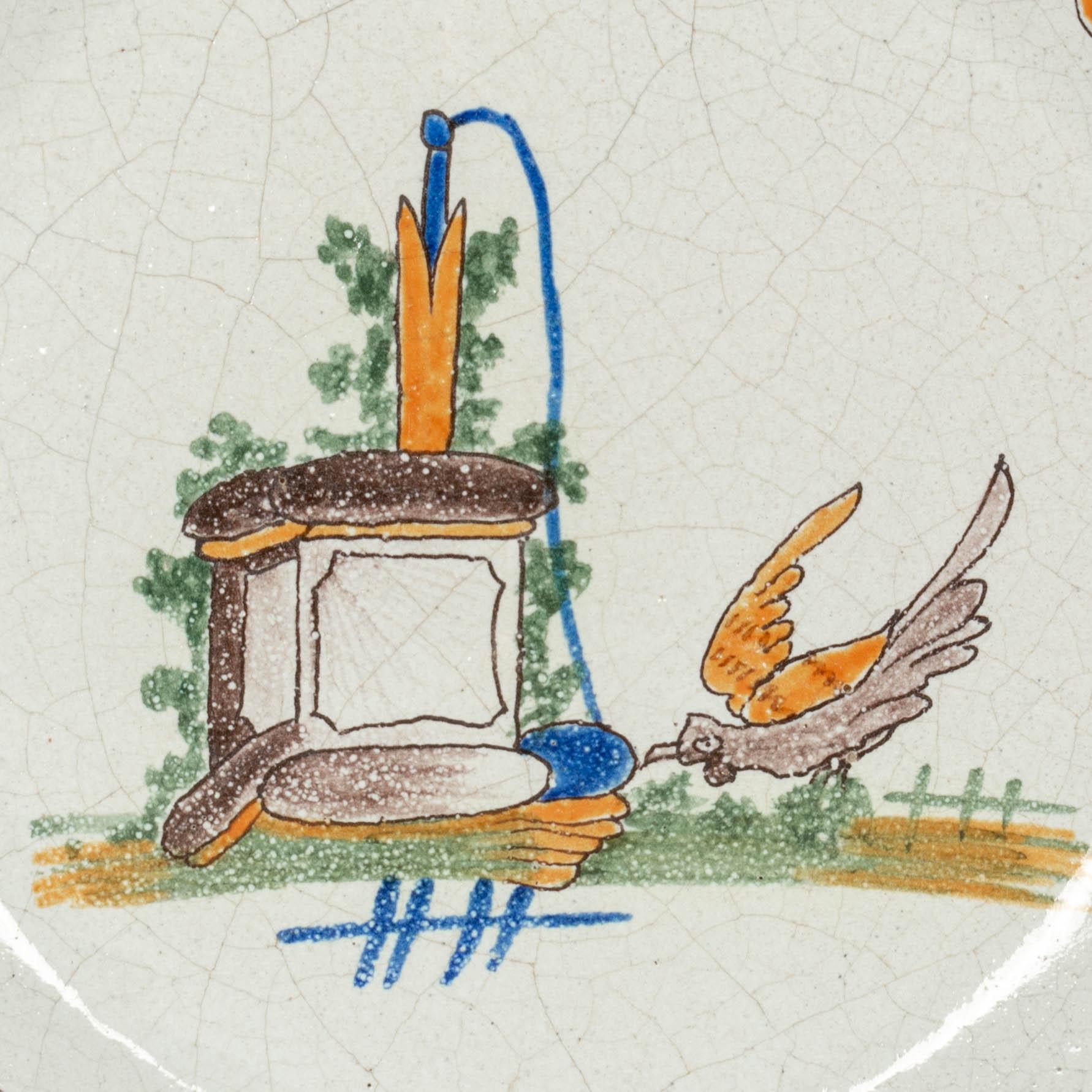 A late 19th century French Malicorne faience pate, hand painted with central image of a well and bird and rim decorated with flowers. Nice quality, thick plate. In good condition with craquelure and small losses to glaze. Pouplard-Beatrix mark on