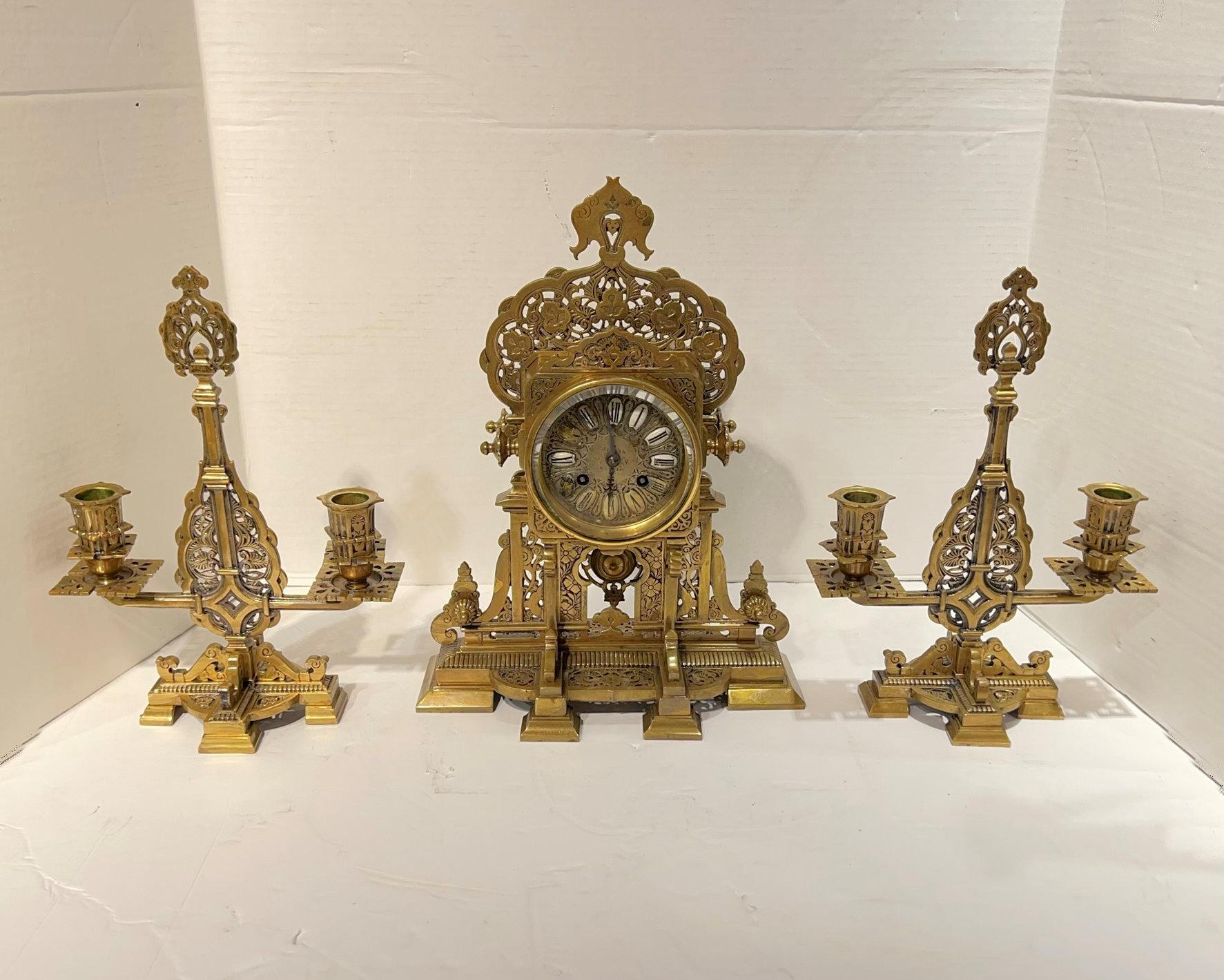 French Mantel Clock and Candelabra Garniture in Islamic Style, circa 1880s. Clock measures 13.5 by 10.5 by 6 inches.