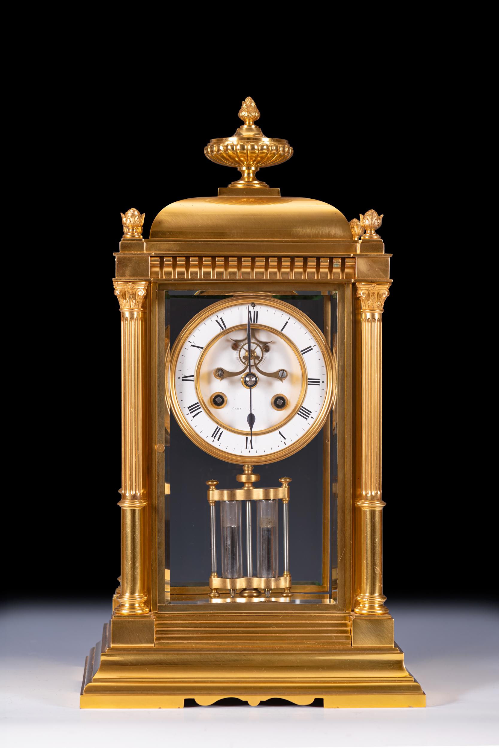 A fine 19th century brass framed mantle clock by S. Marti, surmounted by urn finial above a dentil cornice, supported on outset base the gilt brass case with fluted columns to the corners, the white enamelled dial with Roman numerals with pendulum,