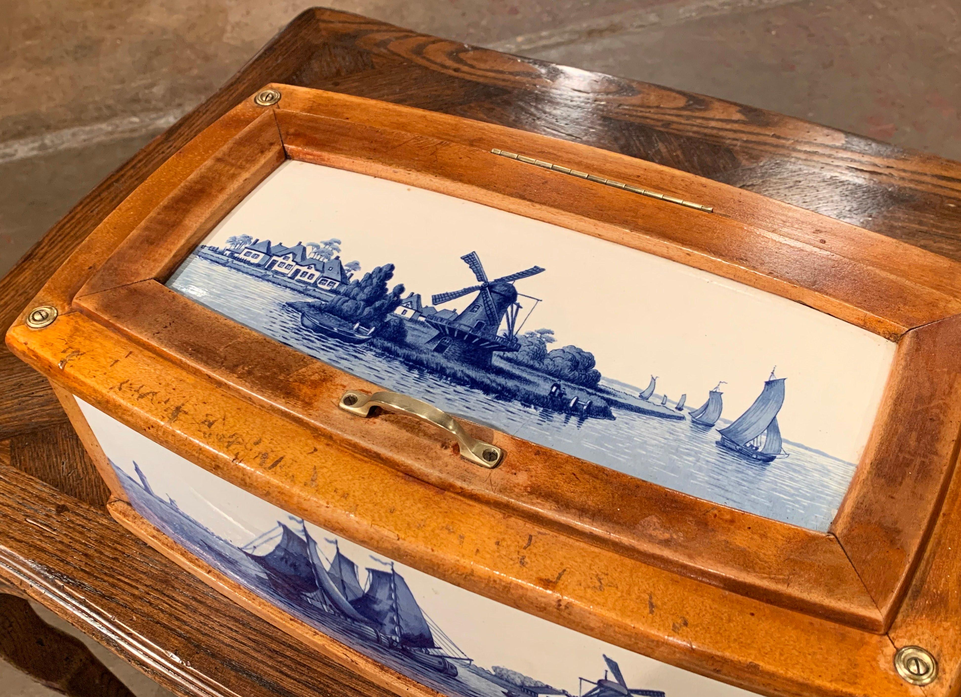Decorate a kitchen counter with this antique, maple and porcelain bread box. Crafted in northern France circa 1870, the colorful box features four bowed sides decorated with hand painted blue and white porcelain tiles in the manner of Delft. The