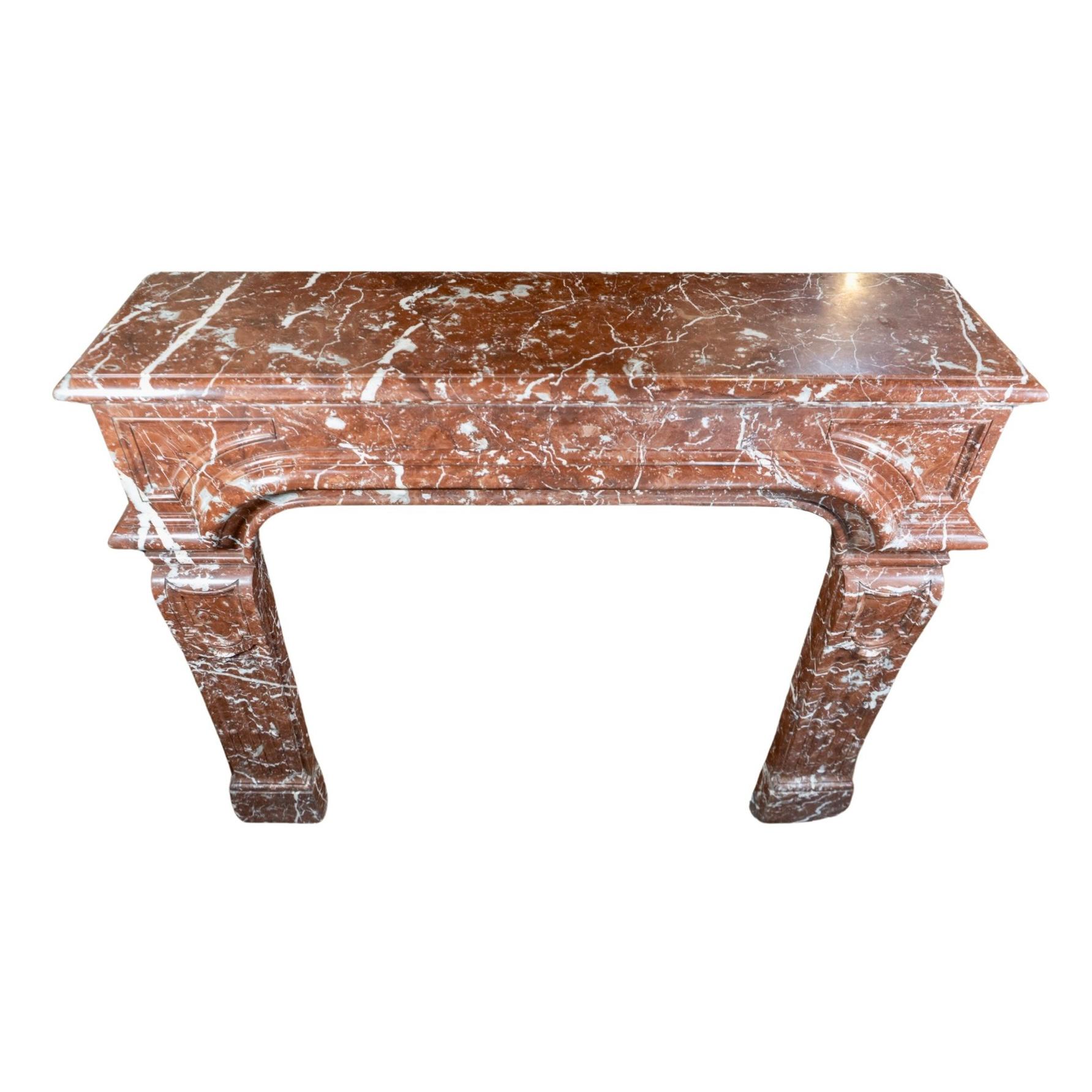 Expertly crafted from French Red Griotte marble, this 1870s mantel features intricate style carvings and rich veining that add a touch of elegance to any space. Made in France, this mantel is a timeless addition to your home.