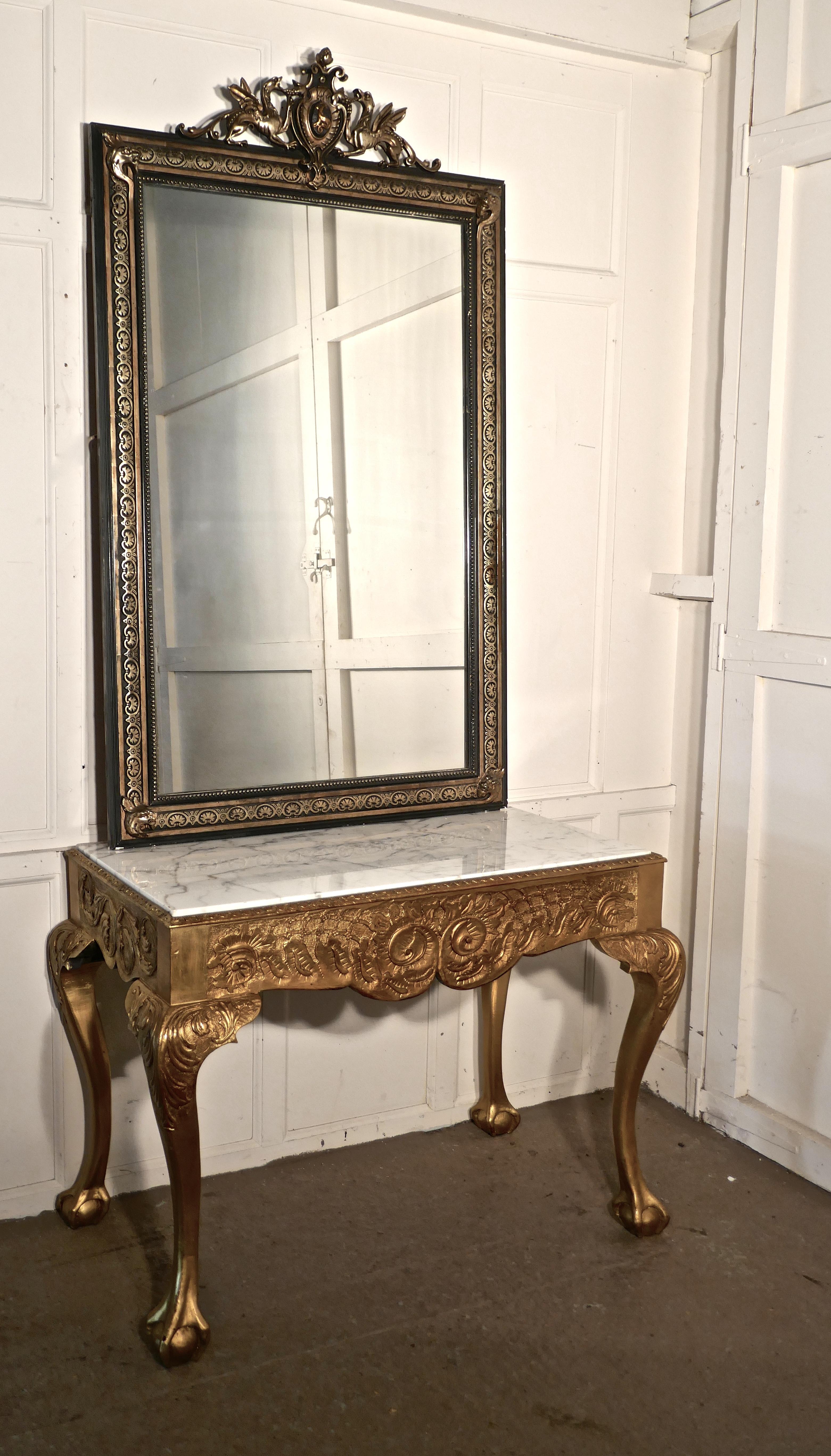 19th century French marble-top gilt console or hall table

This is a very attractive piece, the table is a hard wood carved with a bold scroll and shell decoration, at the front and acanthus leaf carving to the knees of the elegant cabriole legs