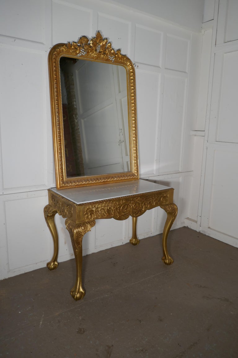 19th century French marble-top gilt console or hall table

This is a very attractive piece, the table is carved with a bold scroll and shell decoration, at the front and acanthus leaf carving to the knees of the elegant cabriole legs which stand on