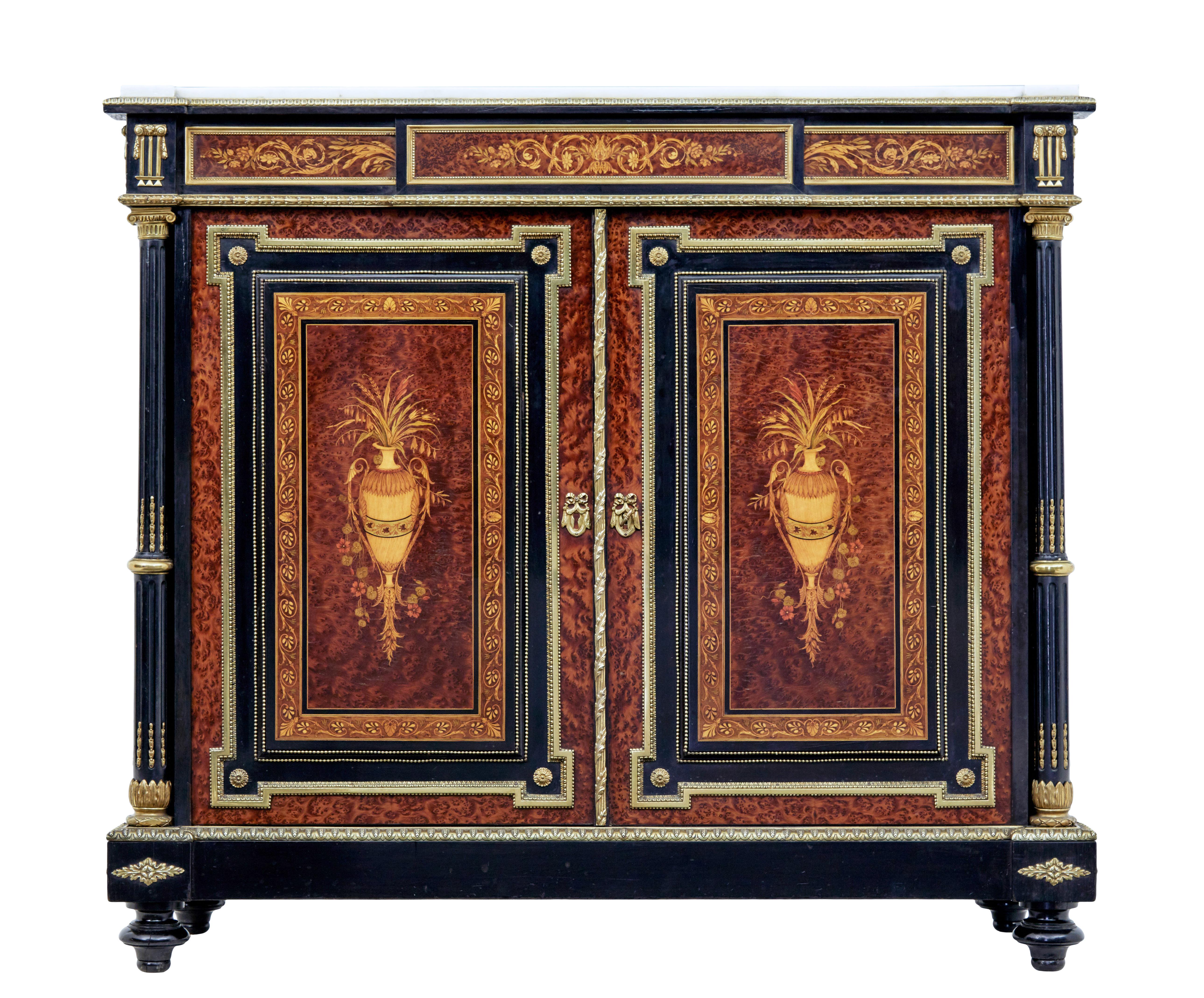 19th century French marble top amboyna sideboard circa 1870.

Fine quality ebonised sideboard with amboyna panels and brass decoration.

Shaped with marble top with feint grey veining boxed in on the top surface by a thick brass edging. Dummy