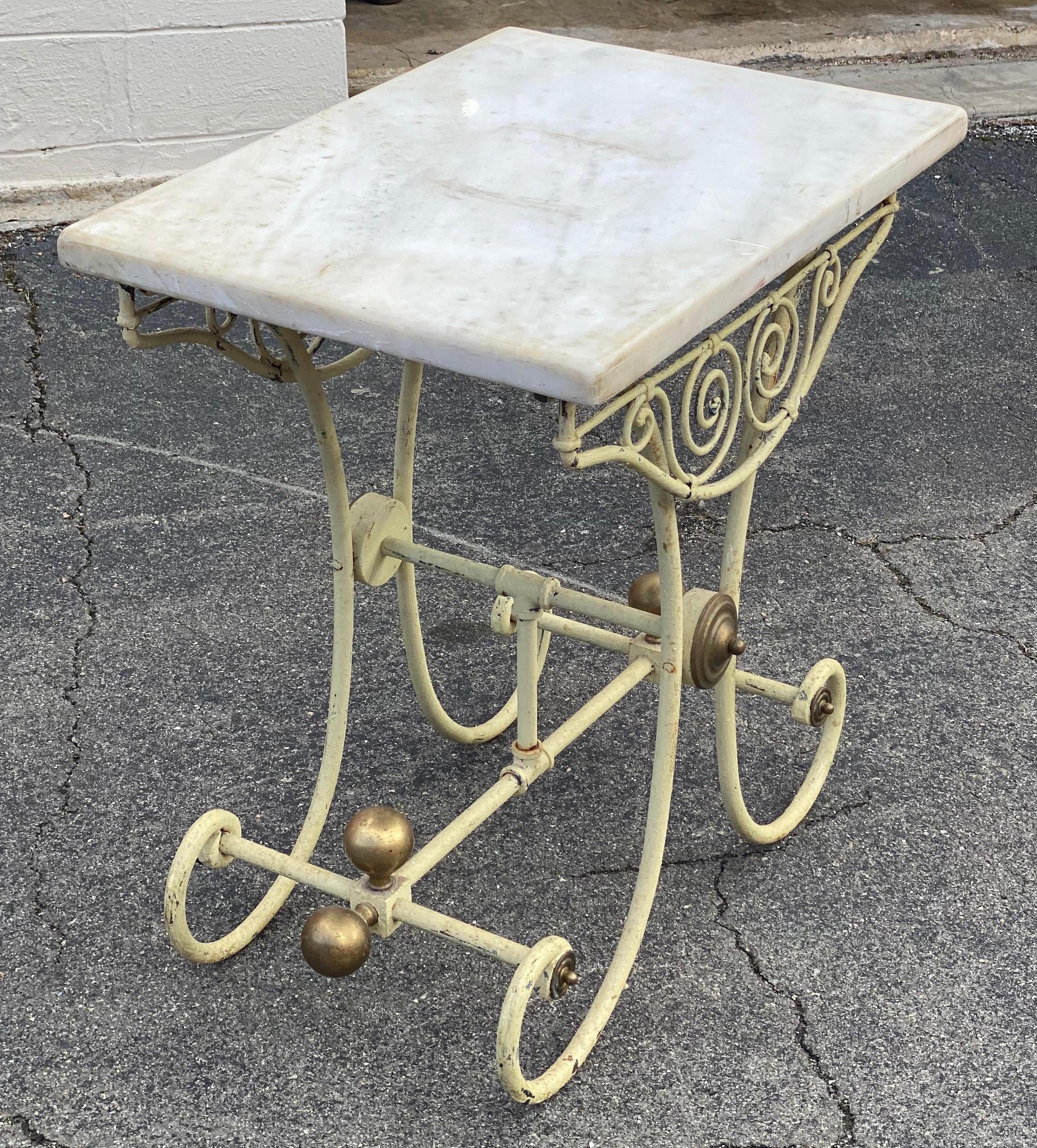 Smaller scale 19th century French marble top, iron and brass pastry table with scrolled apron, brass bosses.
 