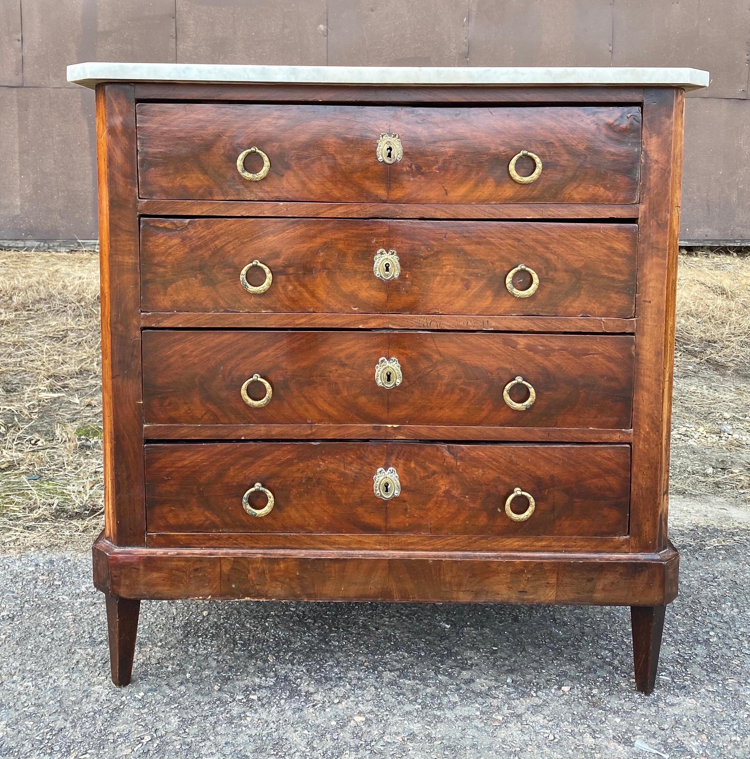 19th century French marble top mahogany chest of drawers with canted corners, tapered feet and original hardware. Great petite size- would work great as a bedside chest or side table.