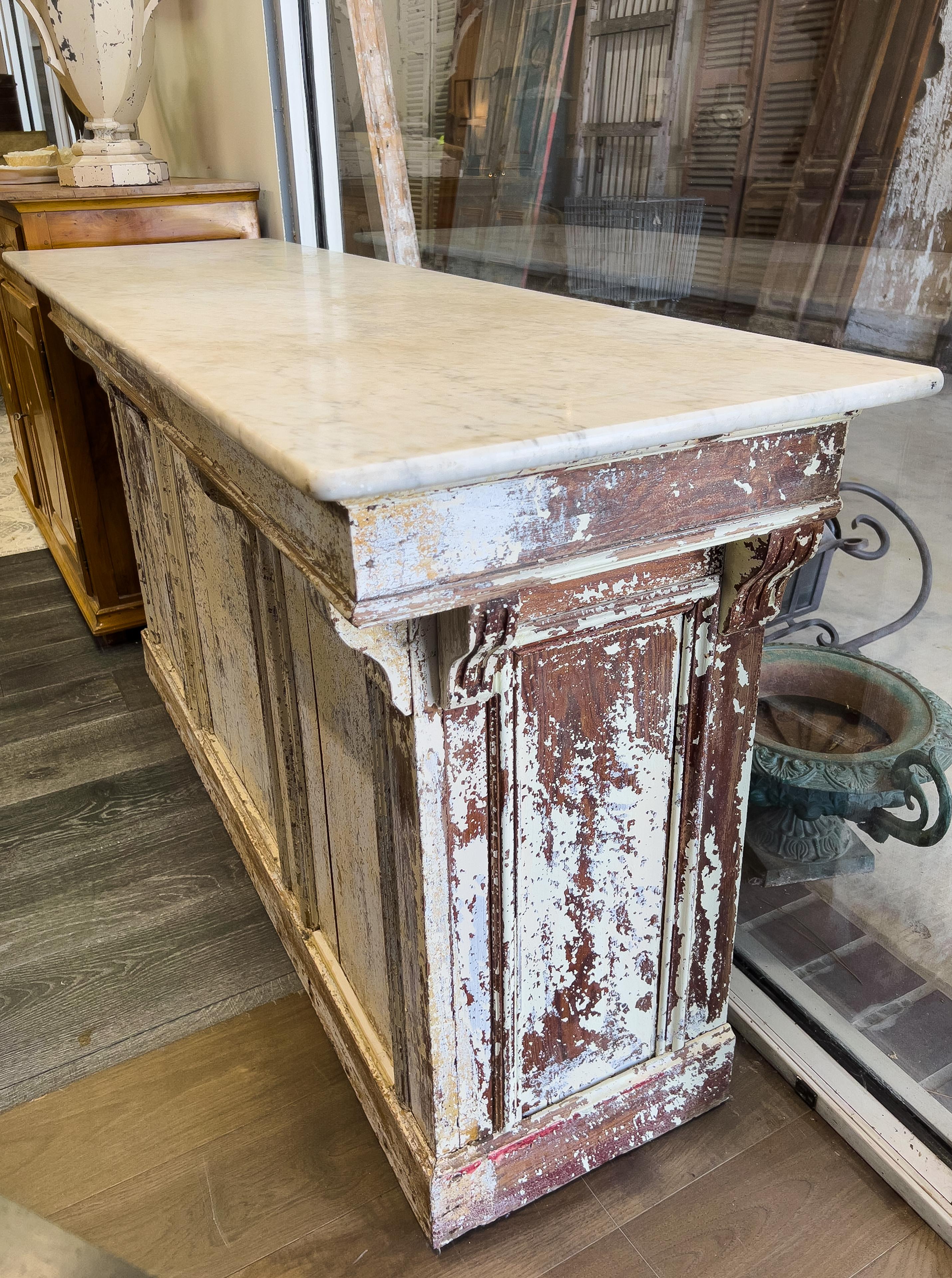 19th century French marble topped bakery counter that is opened on one side with an interior shelf and a drawer above. Block panel detail is on the sides and front.