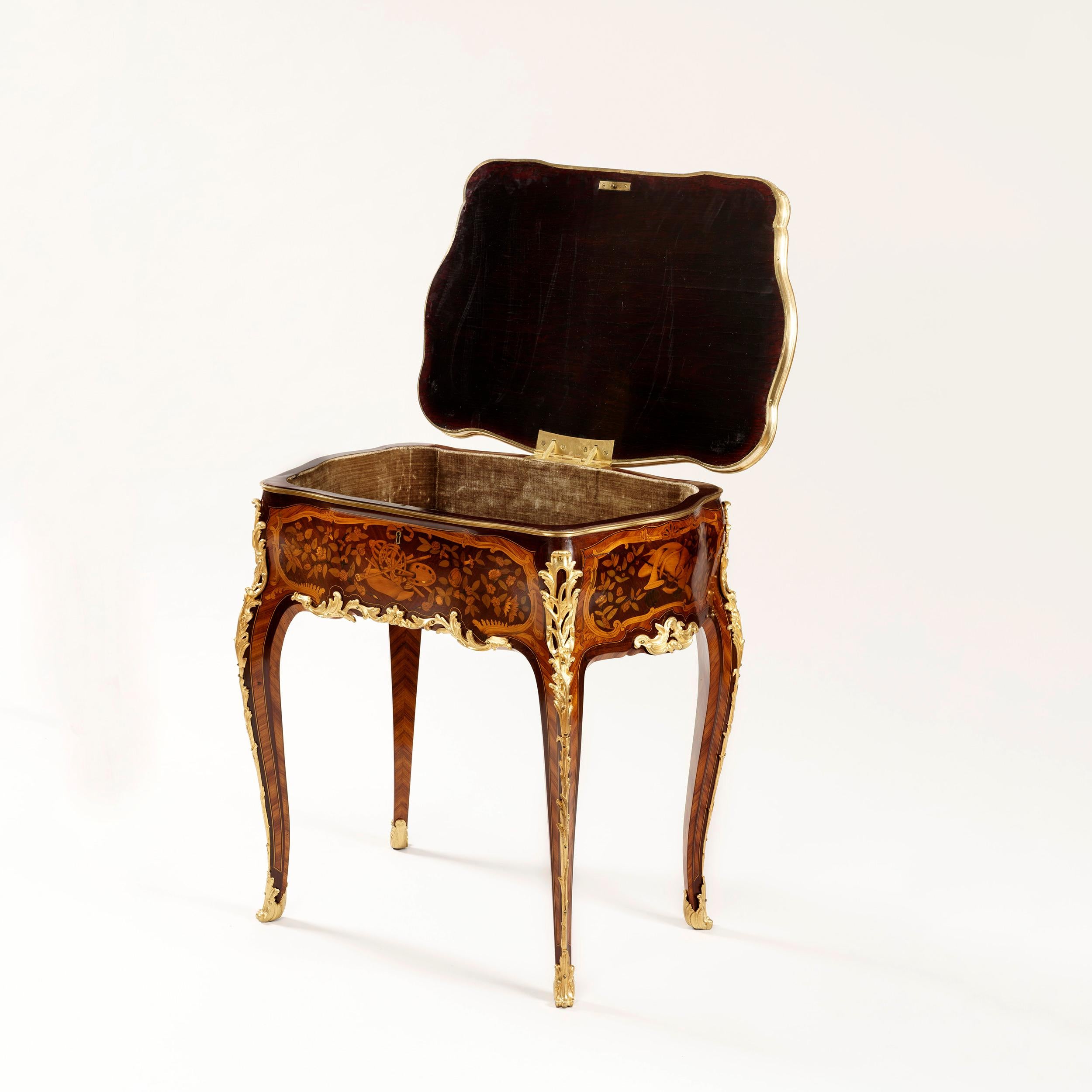 A fine marquetry table in the manner of J-F Oeben

Constructed in kingwood, tulipwood, amaranth and specimen woods, with finely cast gilt bronze mounts; rising from foliate sabot shod cabriole legs, with pierced bronze espagnolettes at the