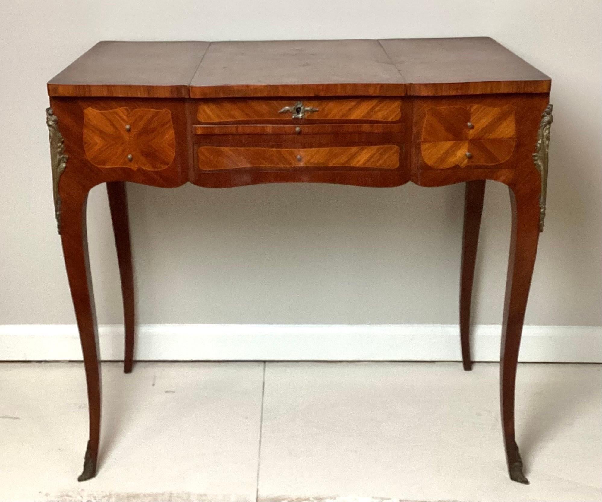 19th century French Marquetry Louis XV dressing table. 33”wide by 19” deep by 30” with mirror open 48” tall. This piece has not been touched in years. Old veneer repair on top and old repair on back. Original used interior. Bronze mounts are