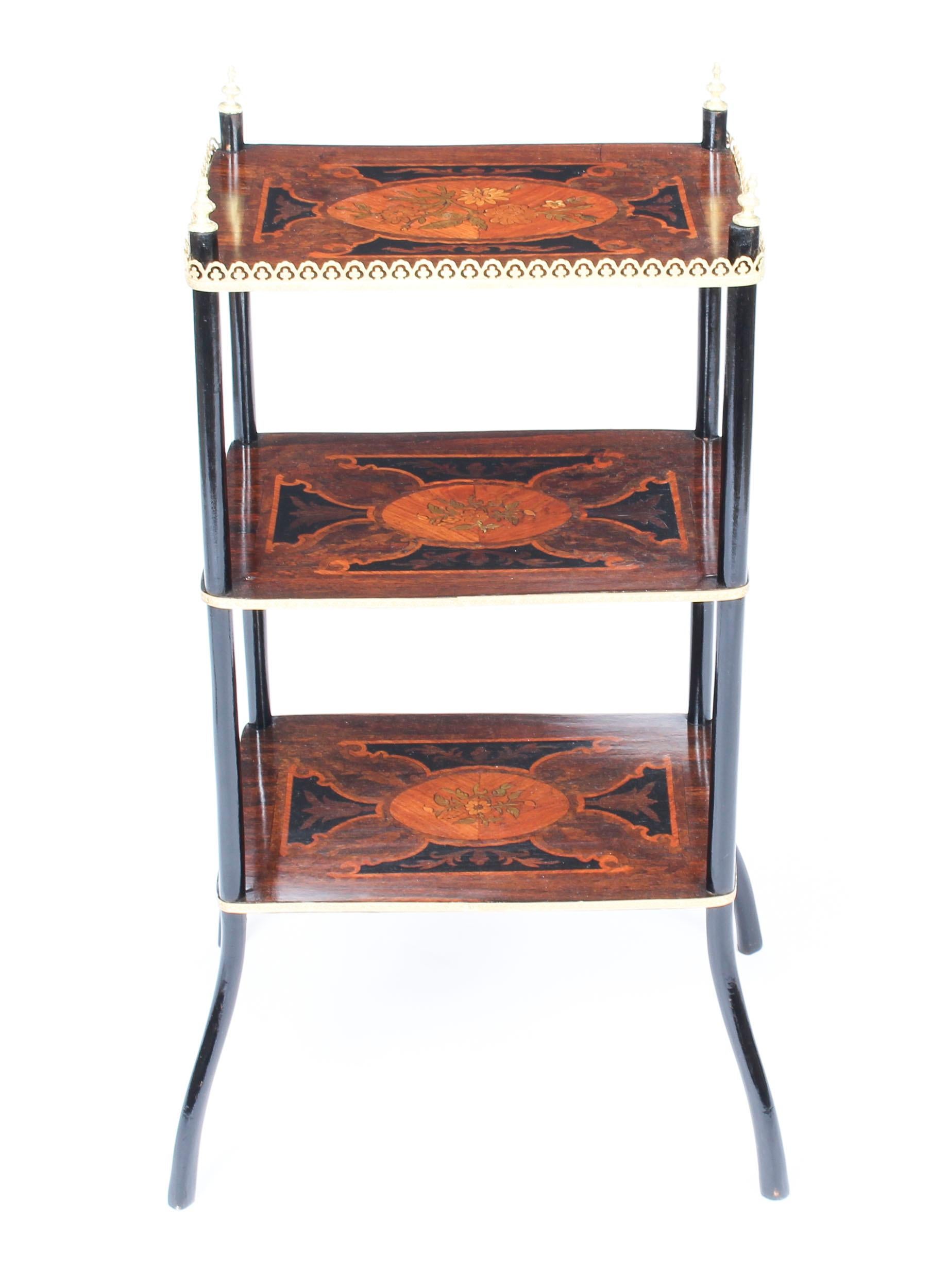This is a truly delightful antique French marquetry and ebonized three-tier étagère or occasional table in Louis XV style, circa 1860 in date.

This elegant table features exquisite ormolu mounts and stands on shaped ebonized legs. Each tier is