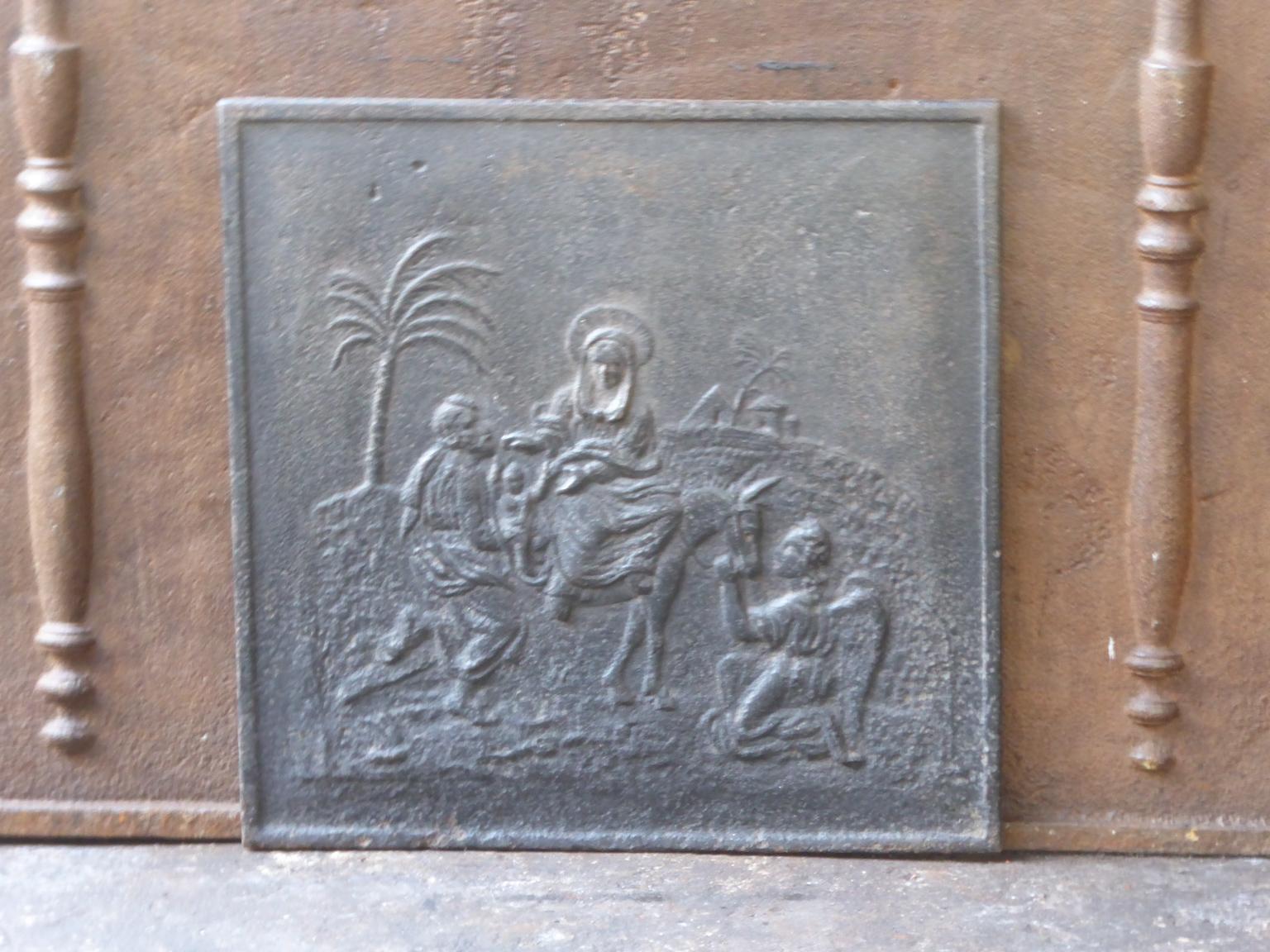 19th century French Napoleon III fireback with Mary and Joseph. The fireback is made of cast iron and has a black / pewter patina. The fireback is in a good condition and does not have cracks.