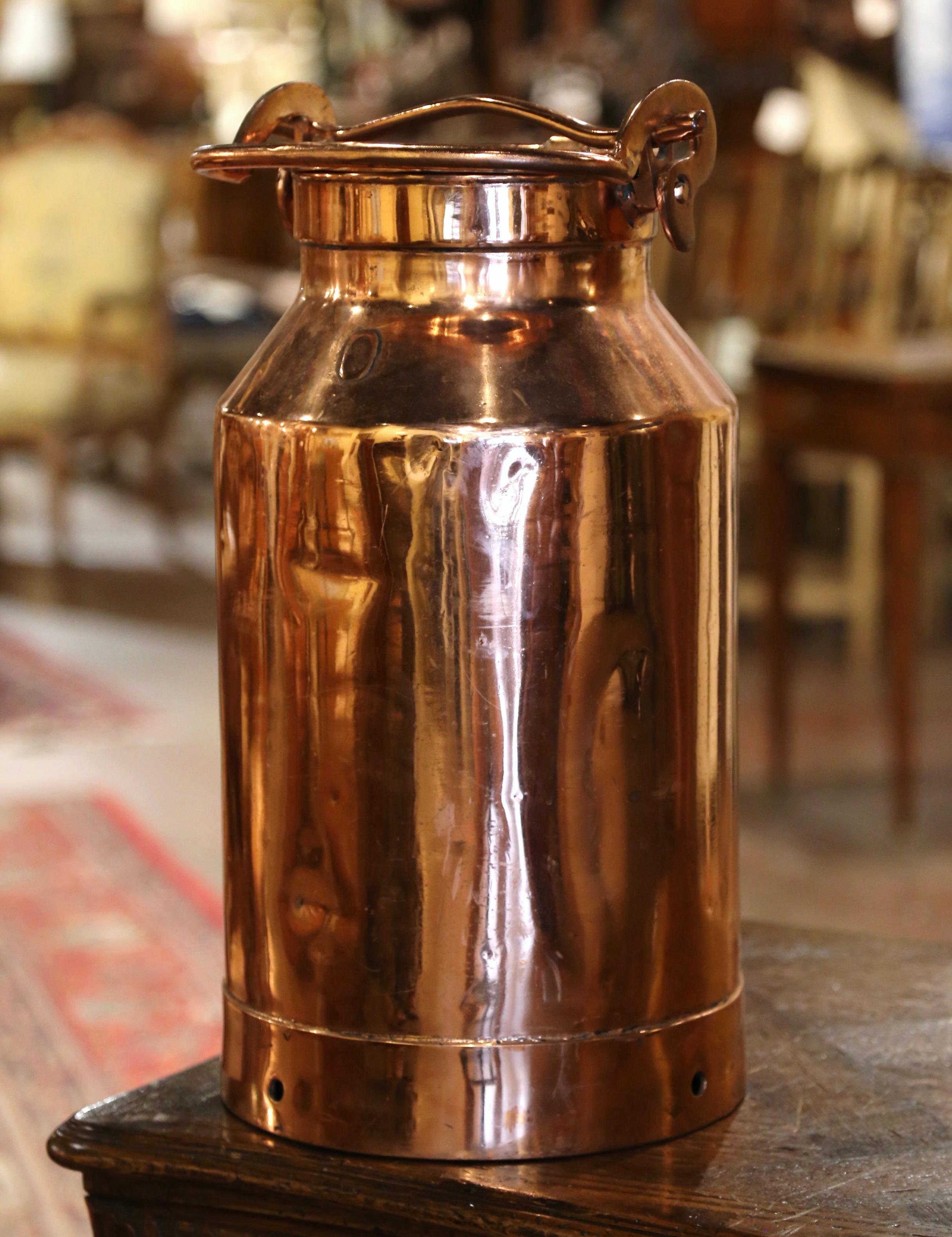 Use this beautiful antique milk can as an umbrella stand by your front door. Crafted in France circa 1880, the tall copper container has a top handle and its original removable lid. The large and heavy pot is in excellent condition and has a rich
