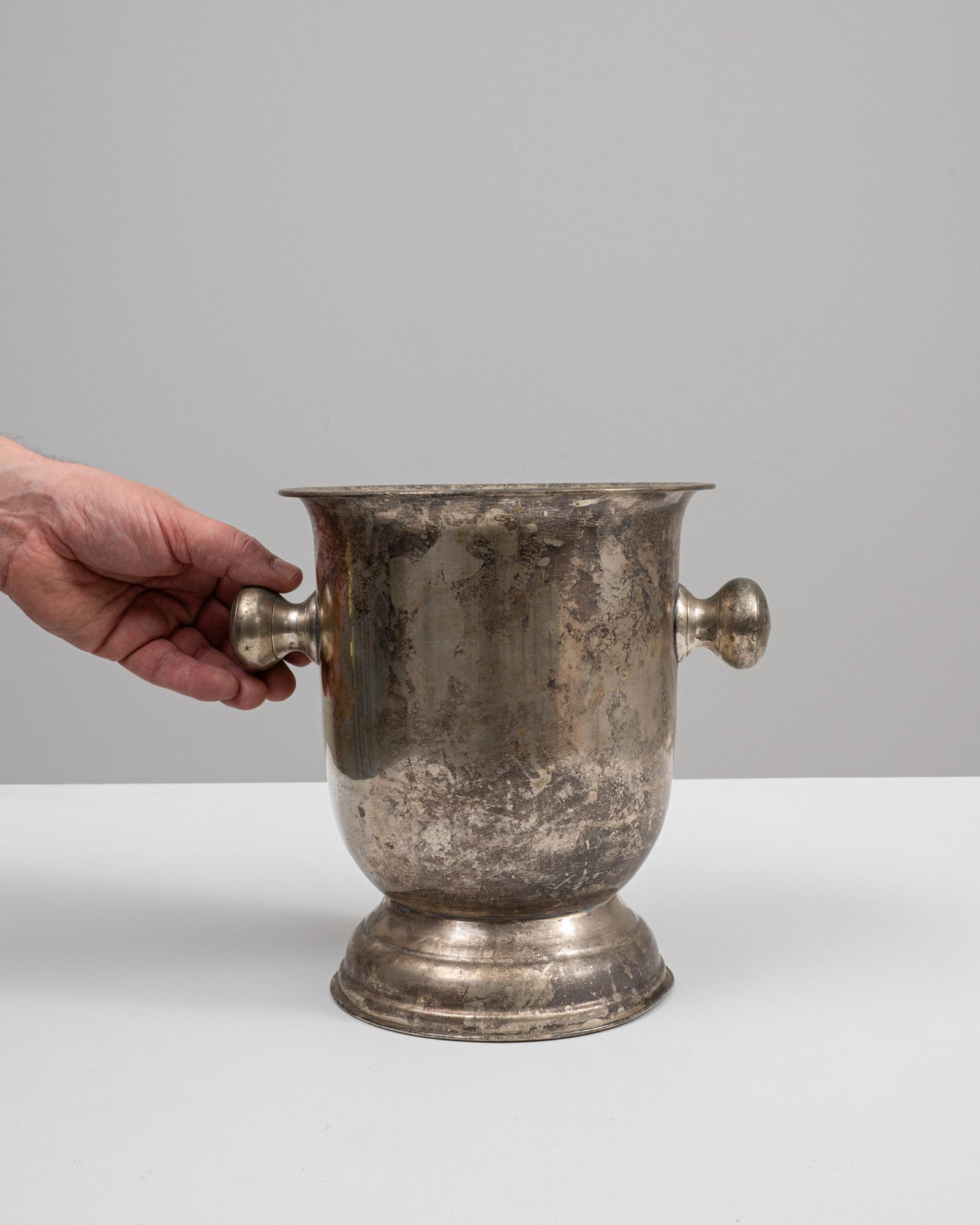 Introducing the exquisite 19th Century French Metal Ice Bucket—a true embodiment of vintage charm and elegance. This ornate piece captures the essence of classic French craftsmanship with its solid, aged metal construction and ornamental handles